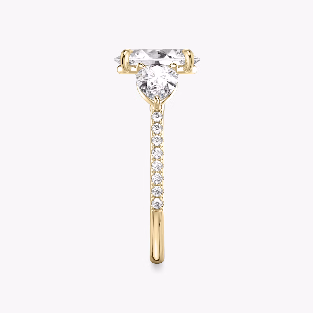 The Three Stone | Oval | 18k | Yellow Gold | bandAccent: Pavé | sideStoneCarat: 0.50ct | sideStoneShape: Pear | diamondOrientation: vertical | caratWeight: other