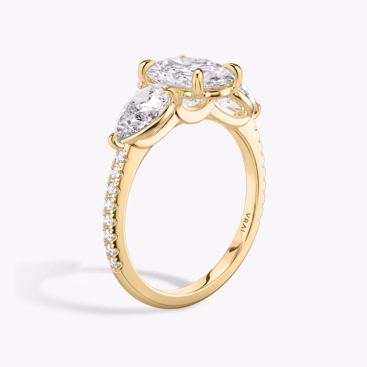 The Three Stone | Oval | 18k | Yellow Gold | bandAccent: Pavé | sideStoneCarat: 0.50ct | sideStoneShape: Pear | diamondOrientation: vertical | caratWeight: other