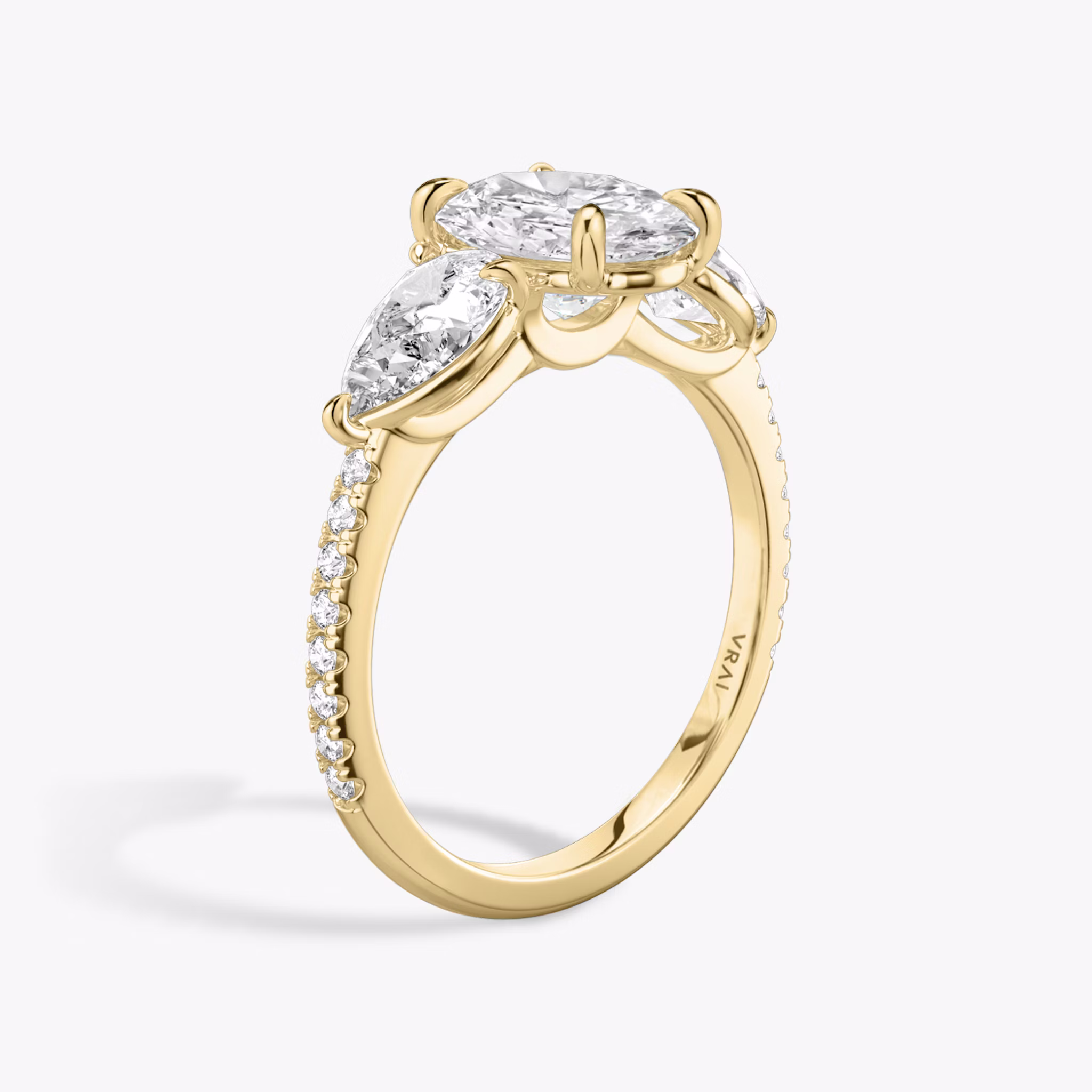 The Three Stone | Oval | 18k | Yellow Gold | bandAccent: Pavé | sideStoneCarat: 0.50ct | sideStoneShape: Pear | diamondOrientation: vertical | caratWeight: other