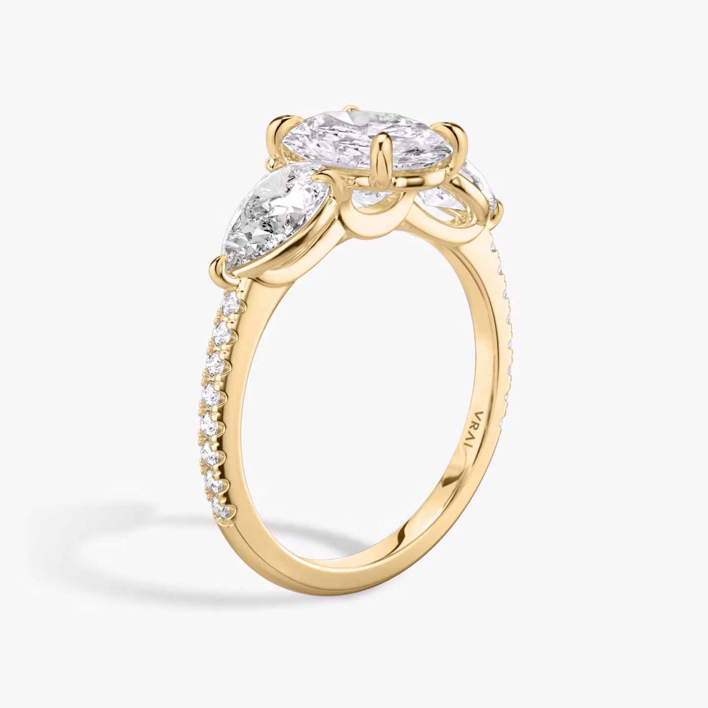 The Three Stone | Oval | 18k | Yellow Gold | bandAccent: Pavé | sideStoneCarat: 0.50ct | sideStoneShape: Pear | diamondOrientation: vertical | caratWeight: other
