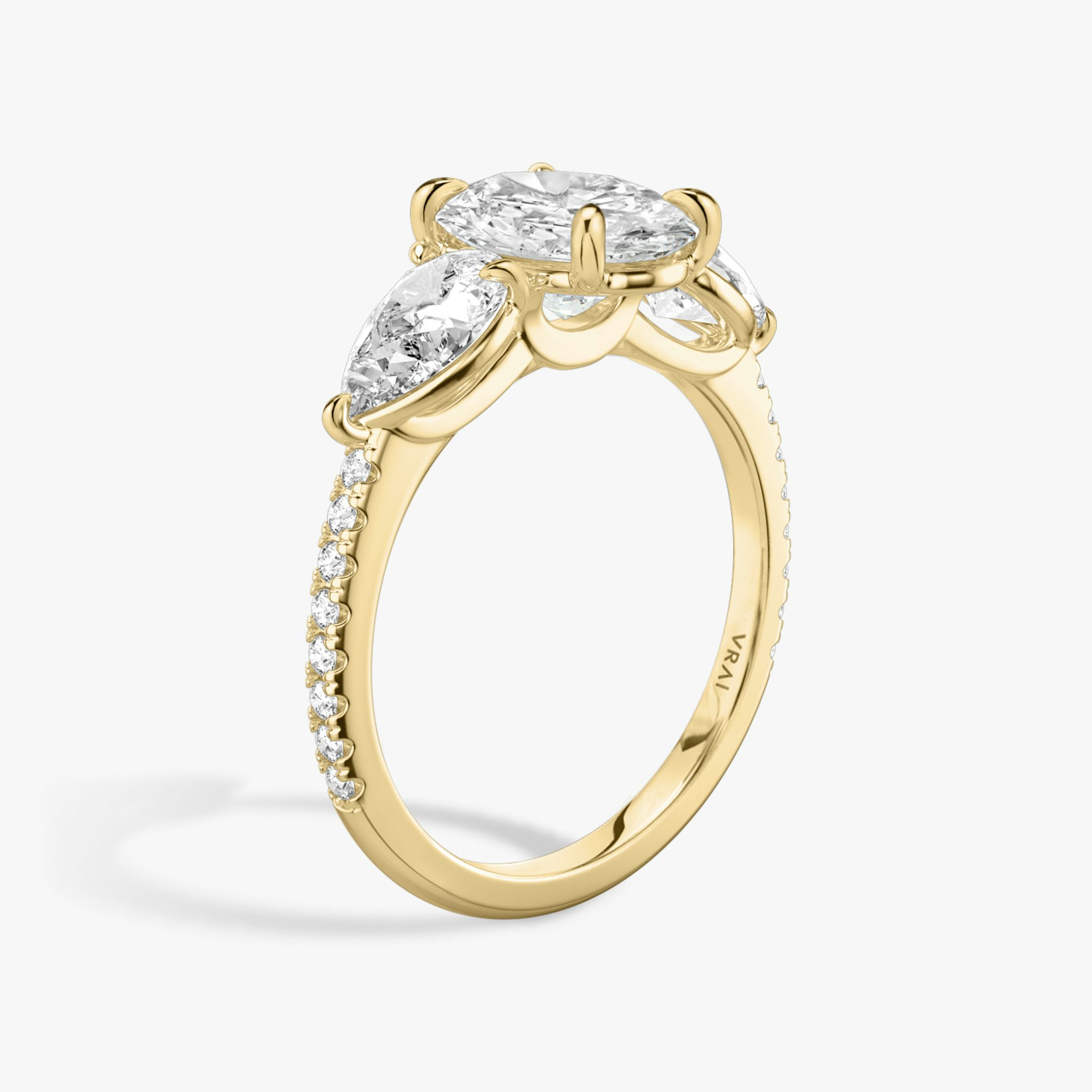 The Three Stone | Oval | 18k | Yellow Gold | bandAccent: Pavé | sideStoneCarat: 0.50ct | sideStoneShape: Pear | diamondOrientation: vertical | caratWeight: other