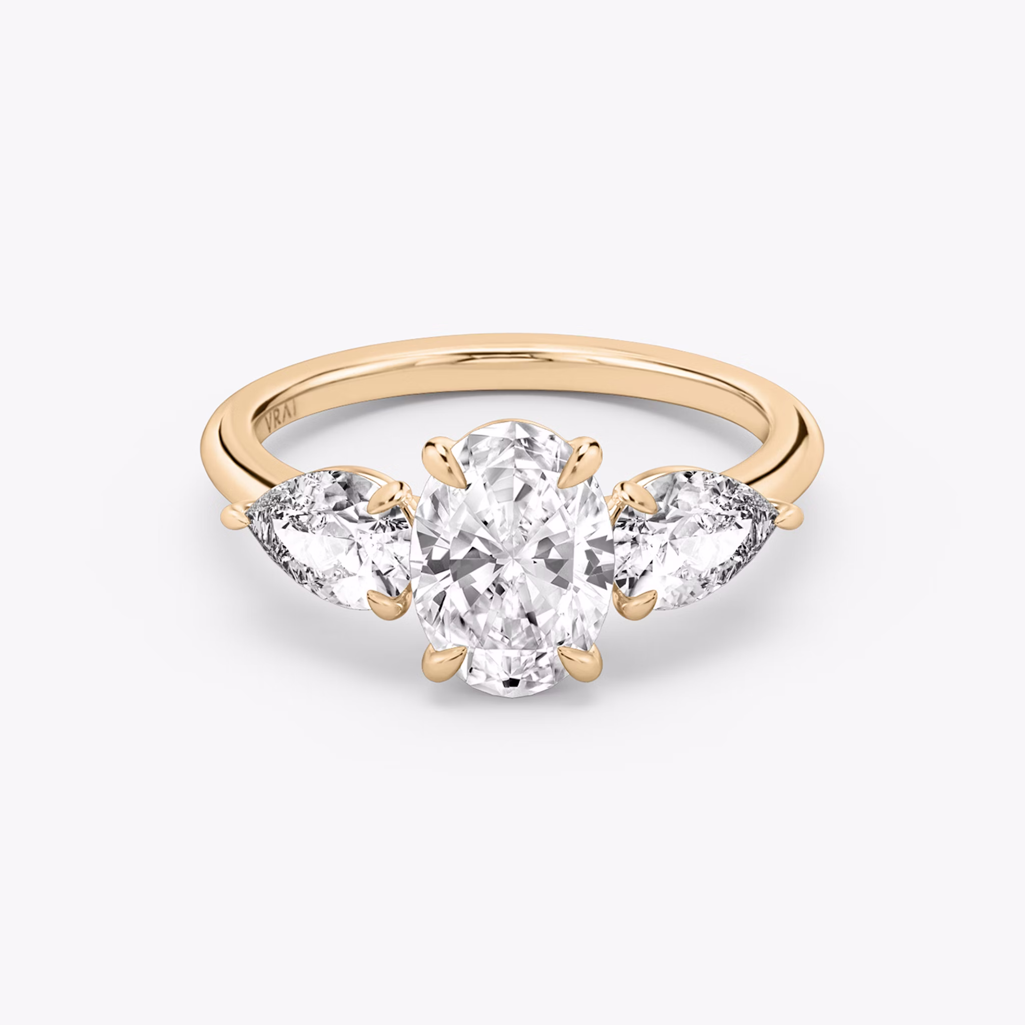 The Three Stone | Oval | 14k | Rose Gold | bandAccent: Plain | sideStoneCarat: 0.50ct | sideStoneShape: Pear | diamondOrientation: vertical | caratWeight: other