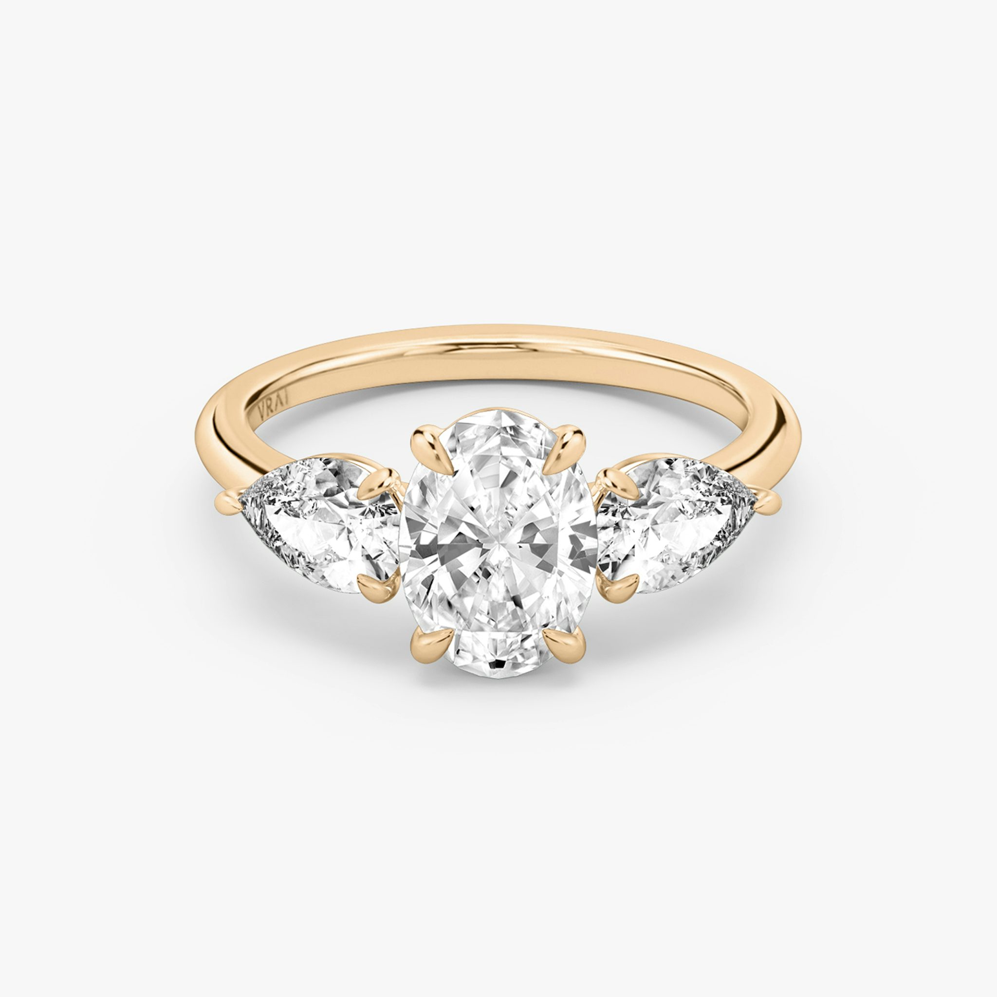 The Three Stone | Oval | 14k | Rose Gold | bandAccent: Plain | sideStoneCarat: 0.50ct | sideStoneShape: Pear | diamondOrientation: vertical | caratWeight: other