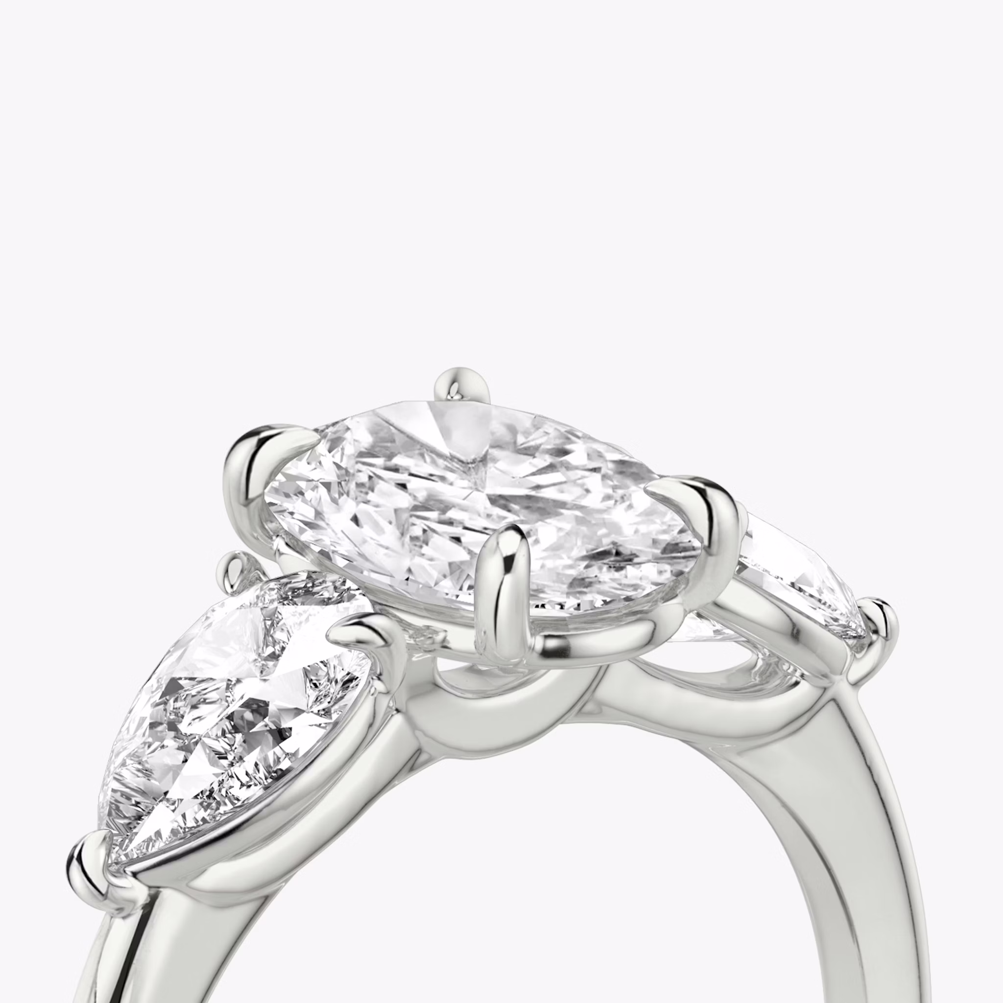 The Three Stone | Oval | 18k | White Gold | bandAccent: Plain | sideStoneCarat: 0.50ct | sideStoneShape: Pear | diamondOrientation: vertical | caratWeight: other