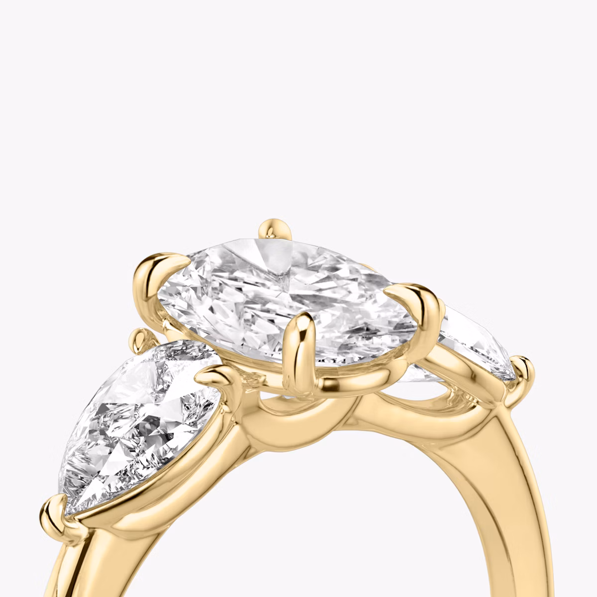 The Three Stone | Oval | 18k | Yellow Gold | bandAccent: Plain | sideStoneCarat: 0.50ct | sideStoneShape: Pear | diamondOrientation: vertical | caratWeight: other