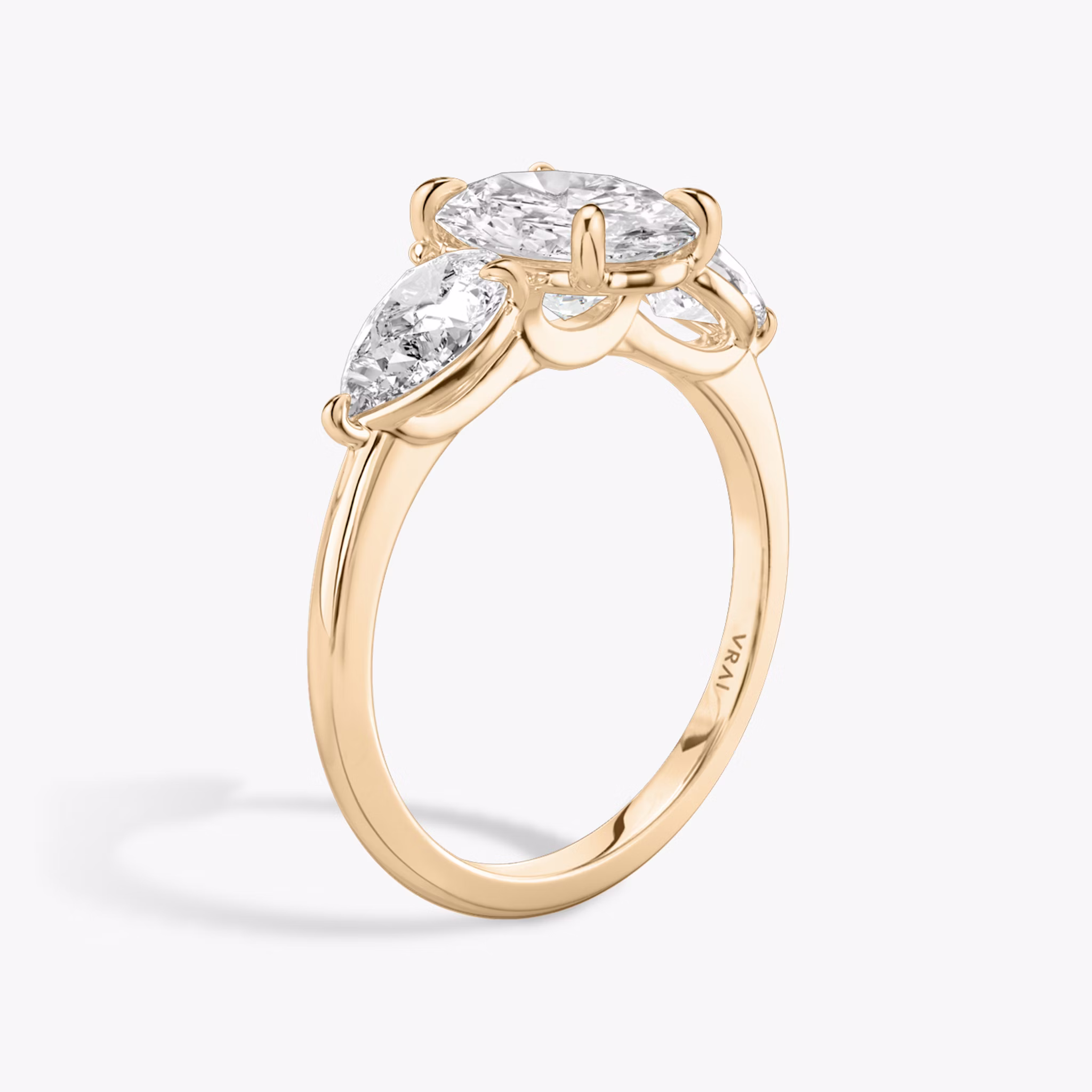 The Three Stone | Oval | 14k | Rose Gold | bandAccent: Plain | sideStoneCarat: 0.50ct | sideStoneShape: Pear | diamondOrientation: vertical | caratWeight: other