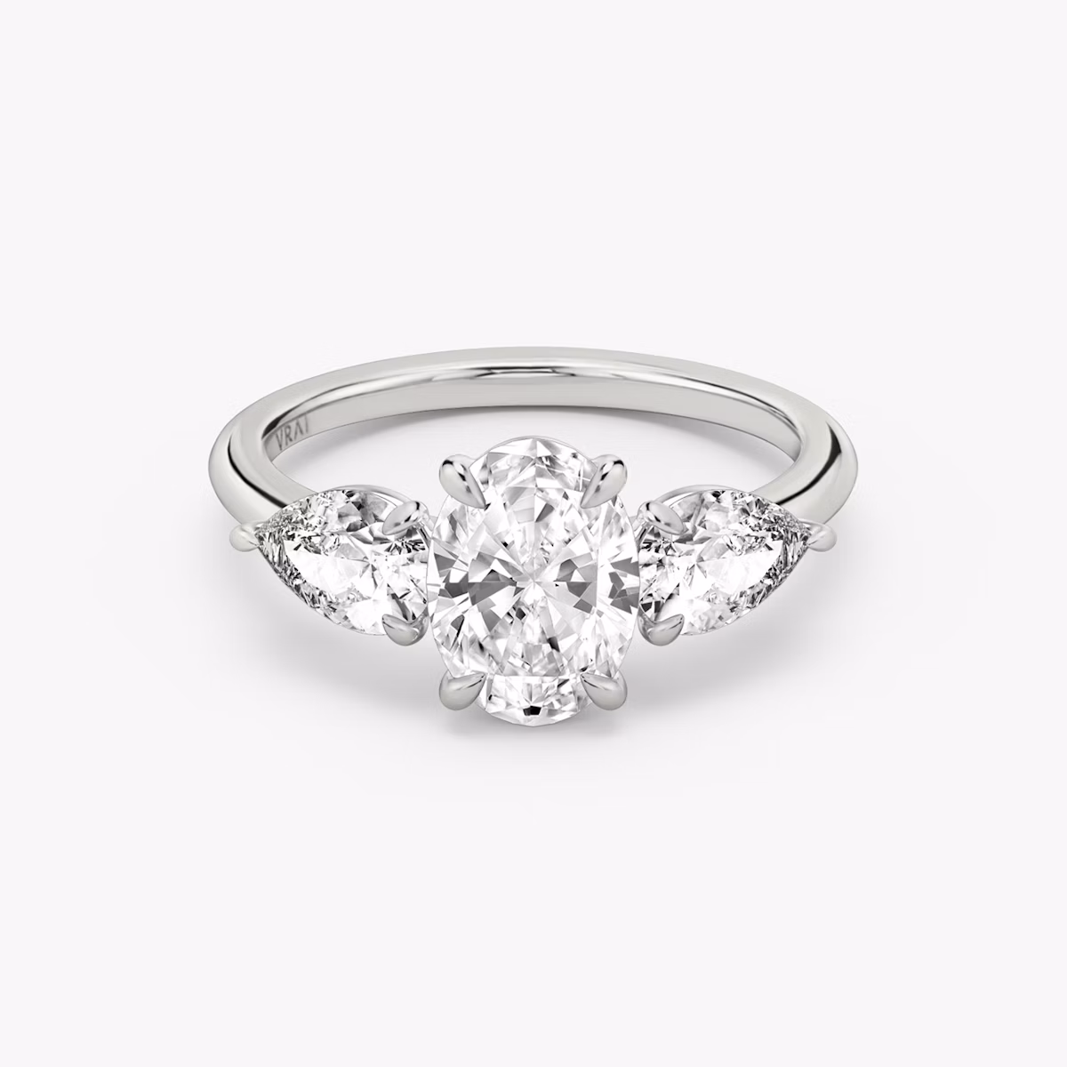 The Three Stone | Oval | Platinum | bandAccent: Plain | sideStoneCarat: 0.50ct | sideStoneShape: Pear | diamondOrientation: vertical | caratWeight: other