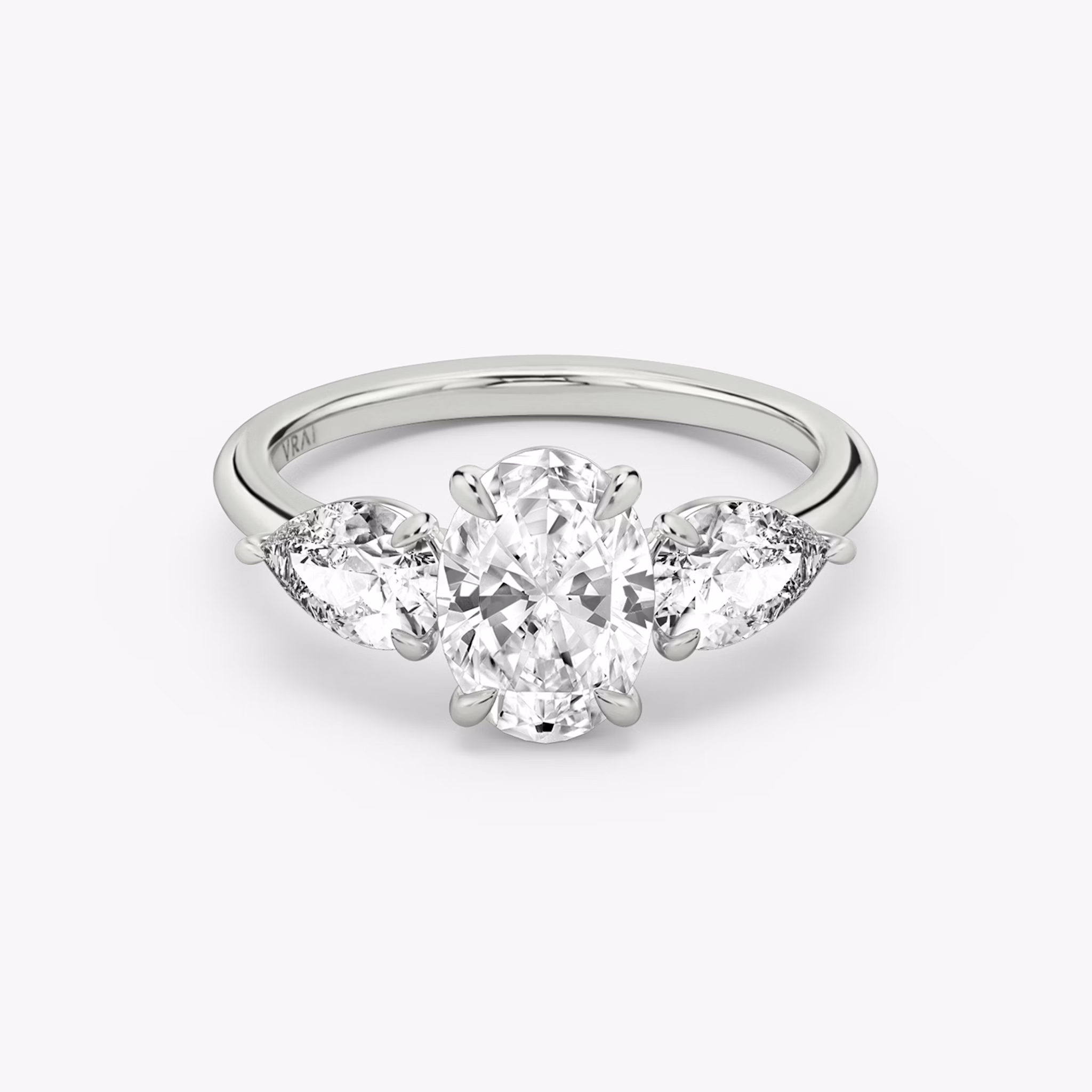 The Three Stone | Oval | 18k | White Gold | bandAccent: Plain | sideStoneCarat: 0.50ct | sideStoneShape: Pear | diamondOrientation: vertical | caratWeight: other