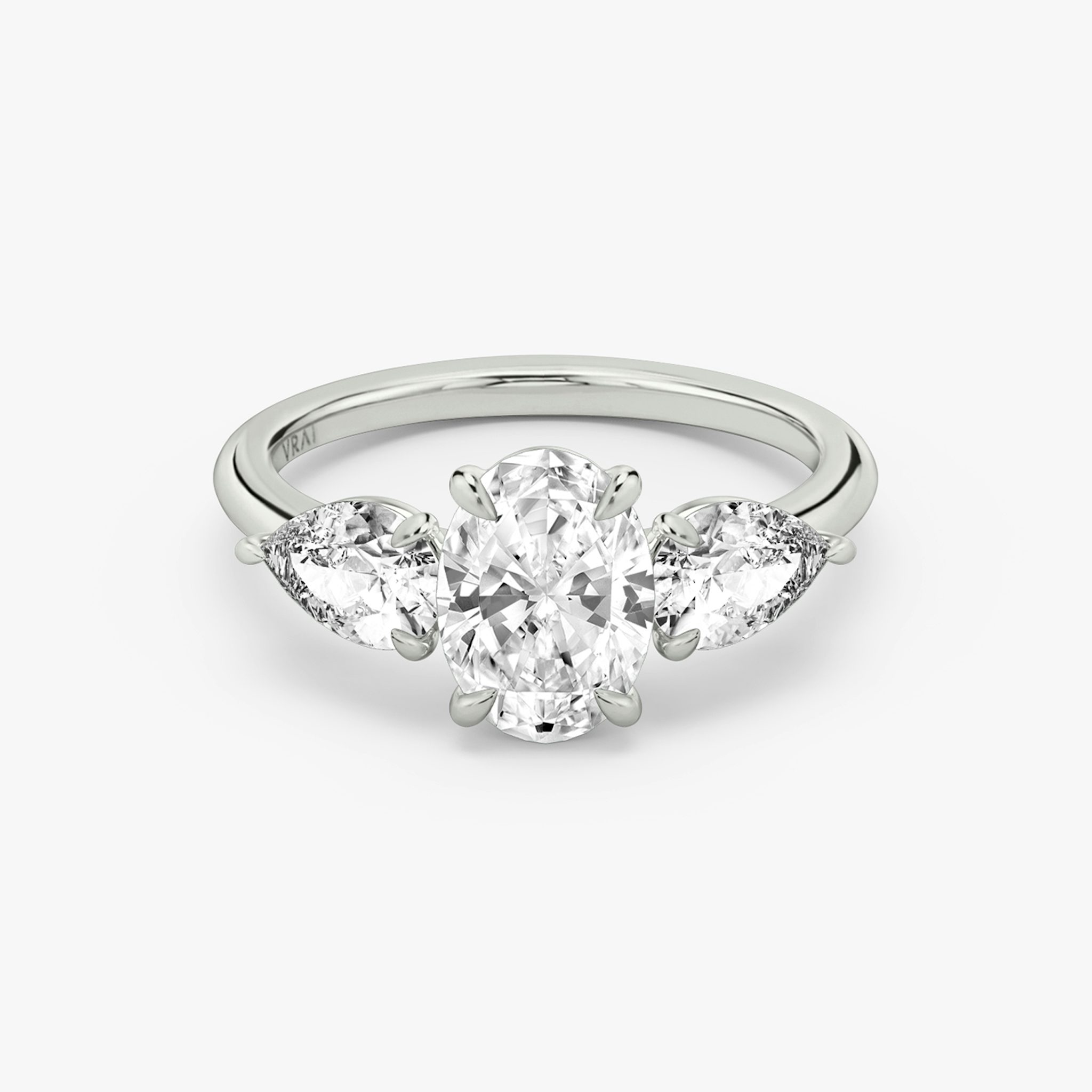 The Three Stone | Oval | 18k | White Gold | bandAccent: Plain | sideStoneCarat: 0.50ct | sideStoneShape: Pear | diamondOrientation: vertical | caratWeight: other