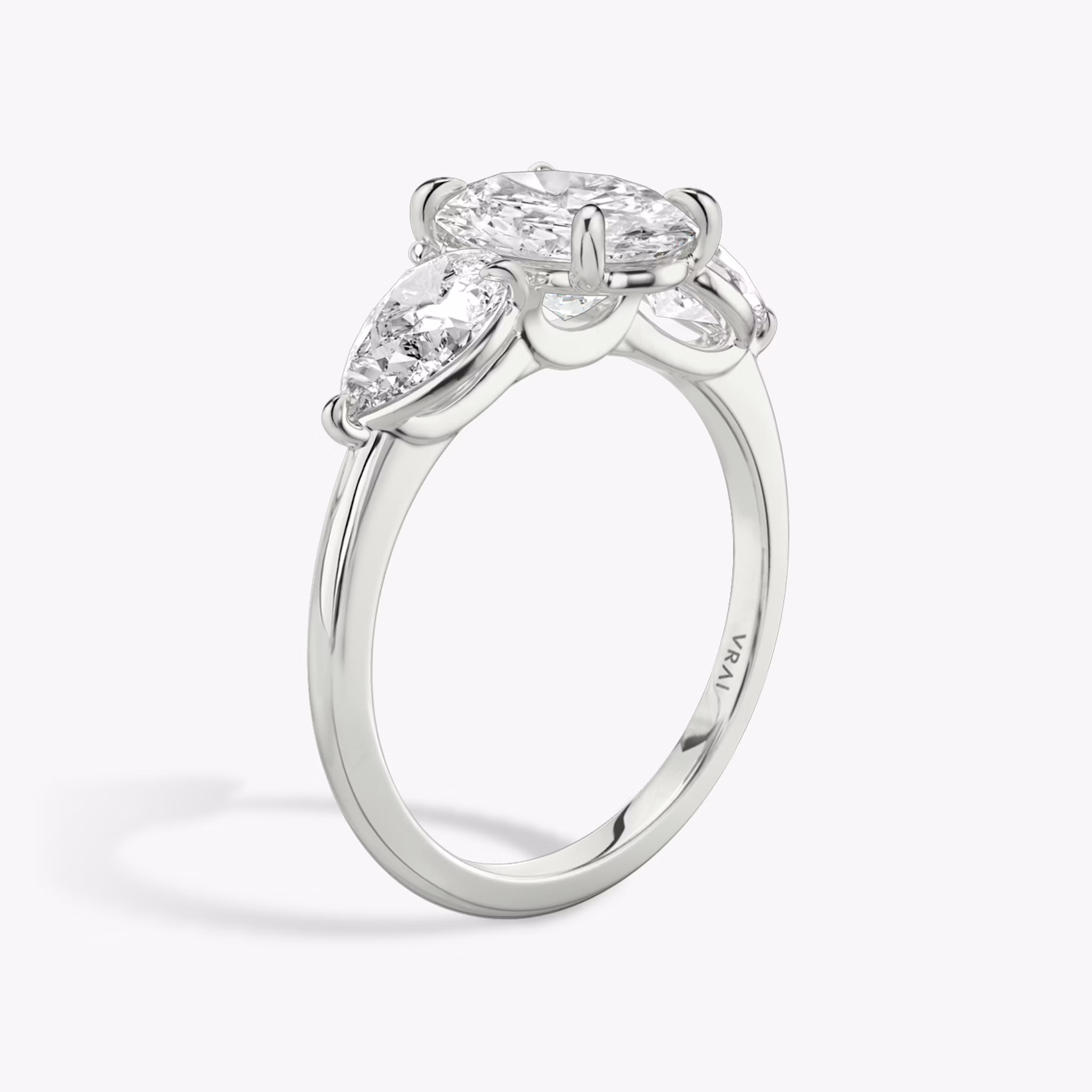 The Three Stone | Oval | 18k | White Gold | bandAccent: Plain | sideStoneCarat: 0.50ct | sideStoneShape: Pear | diamondOrientation: vertical | caratWeight: other