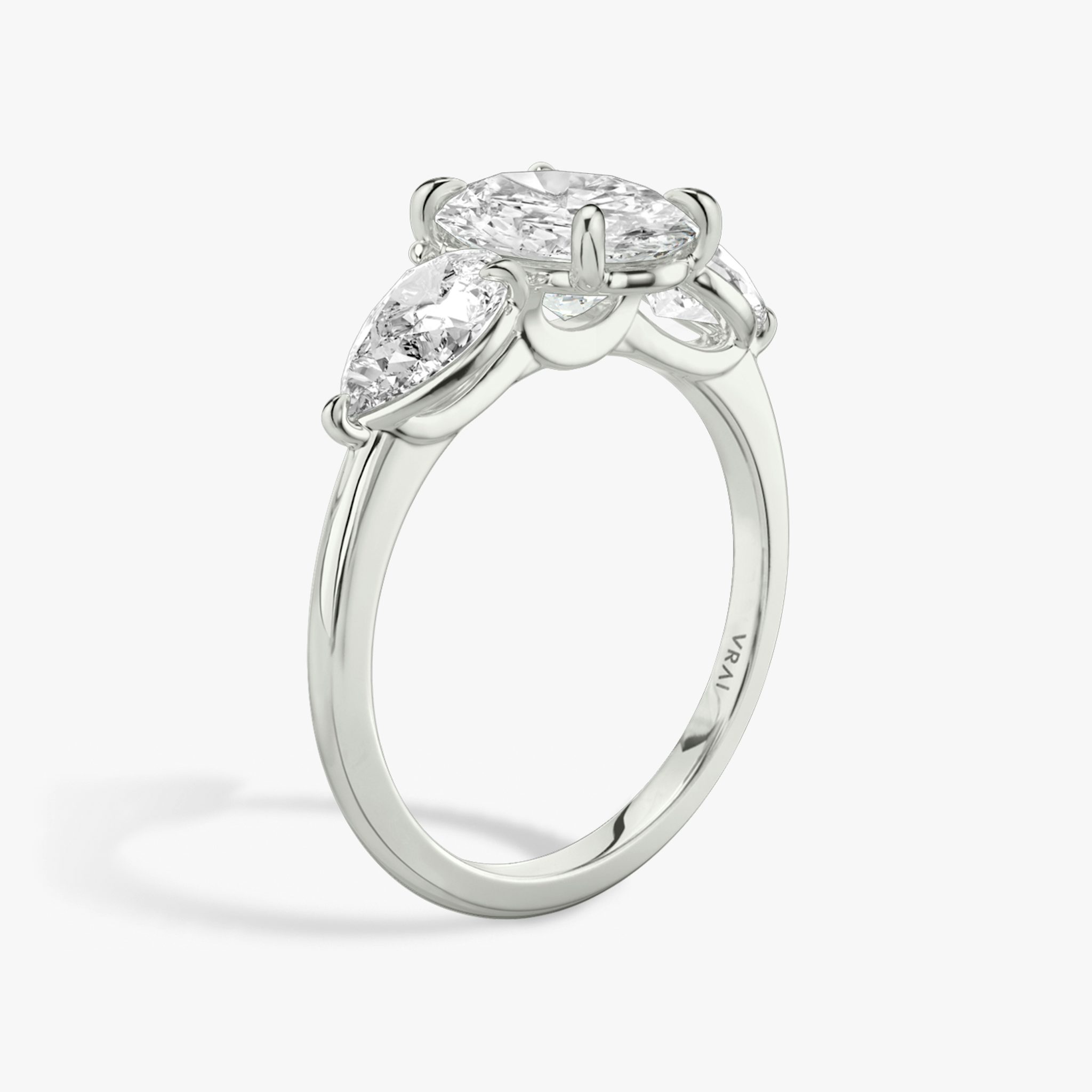The Three Stone | Oval | 18k | White Gold | bandAccent: Plain | sideStoneCarat: 0.50ct | sideStoneShape: Pear | diamondOrientation: vertical | caratWeight: other