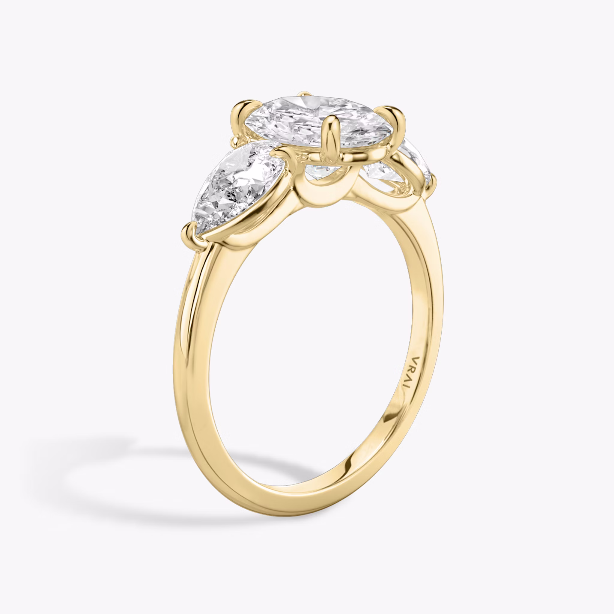 The Three Stone | Oval | 18k | Yellow Gold | bandAccent: Plain | sideStoneCarat: 0.50ct | sideStoneShape: Pear | diamondOrientation: vertical | caratWeight: other