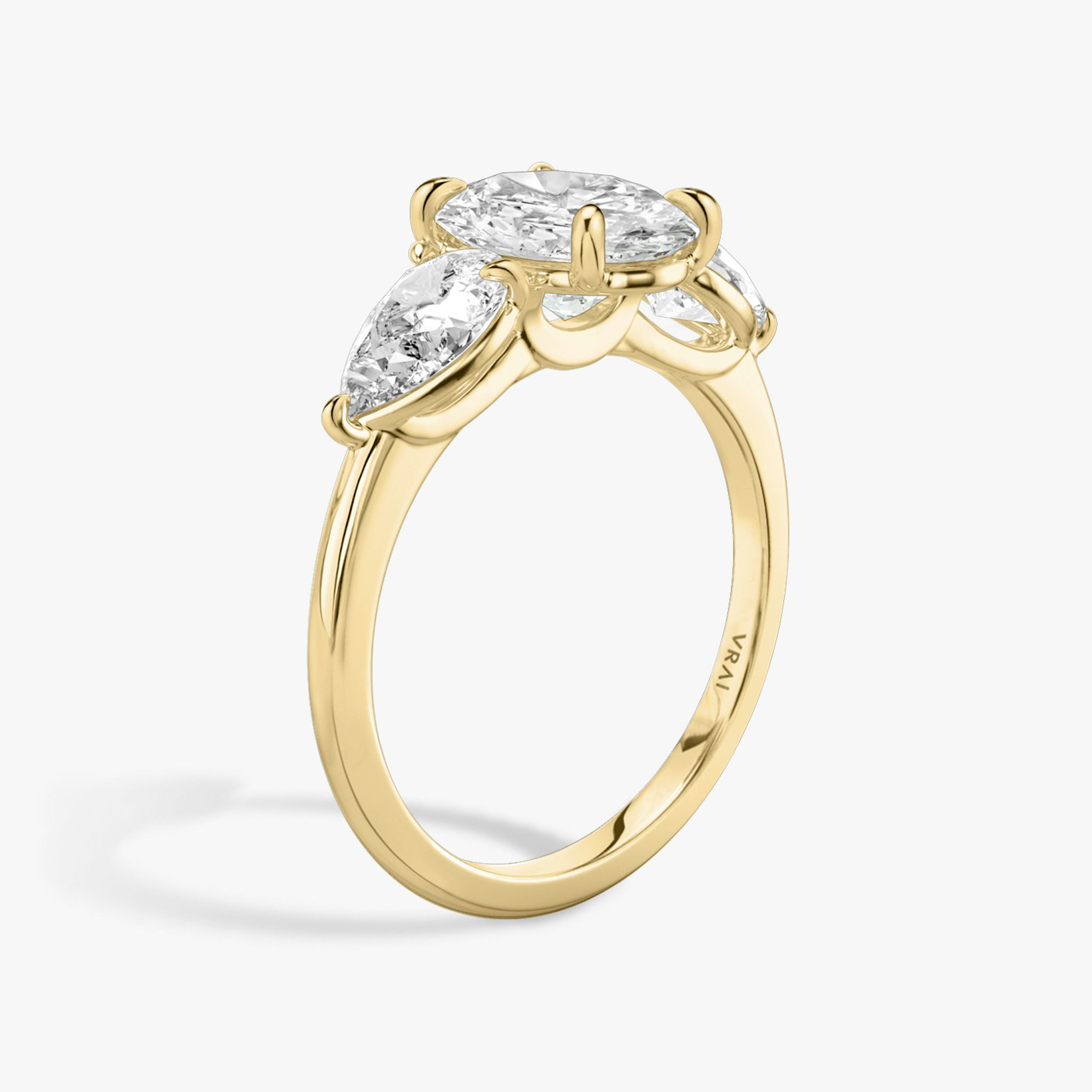 The Three Stone | Oval | 18k | Yellow Gold | bandAccent: Plain | sideStoneCarat: 0.50ct | sideStoneShape: Pear | diamondOrientation: vertical | caratWeight: other