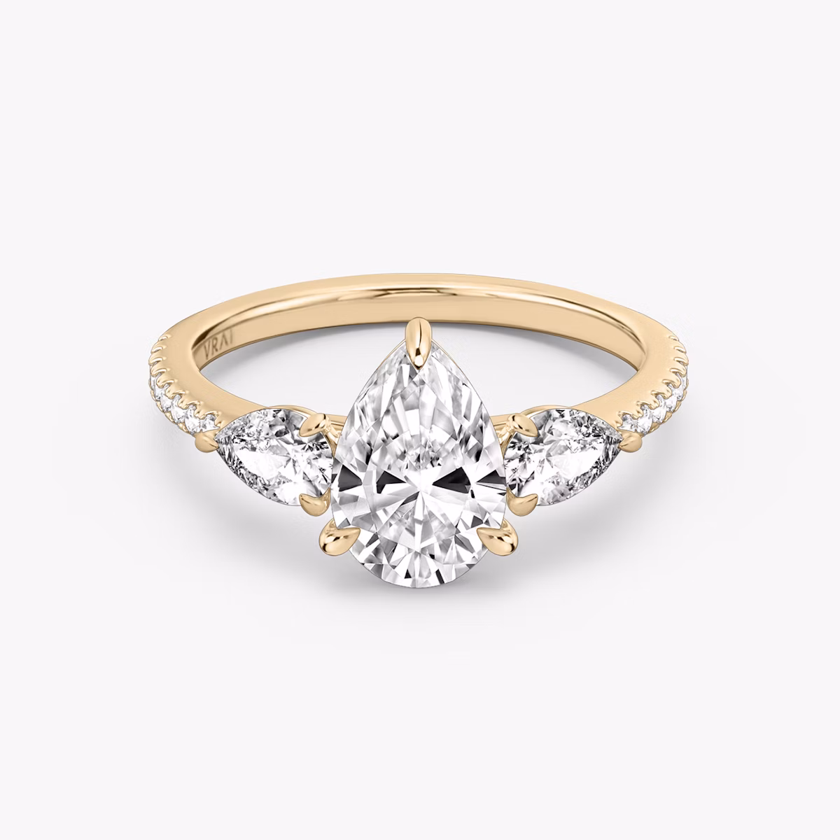 The Three Stone | Pear | 14k | Rose Gold | bandAccent: Pavé | sideStoneCarat: 0.25ct | sideStoneShape: Pear | diamondOrientation: vertical | caratWeight: other