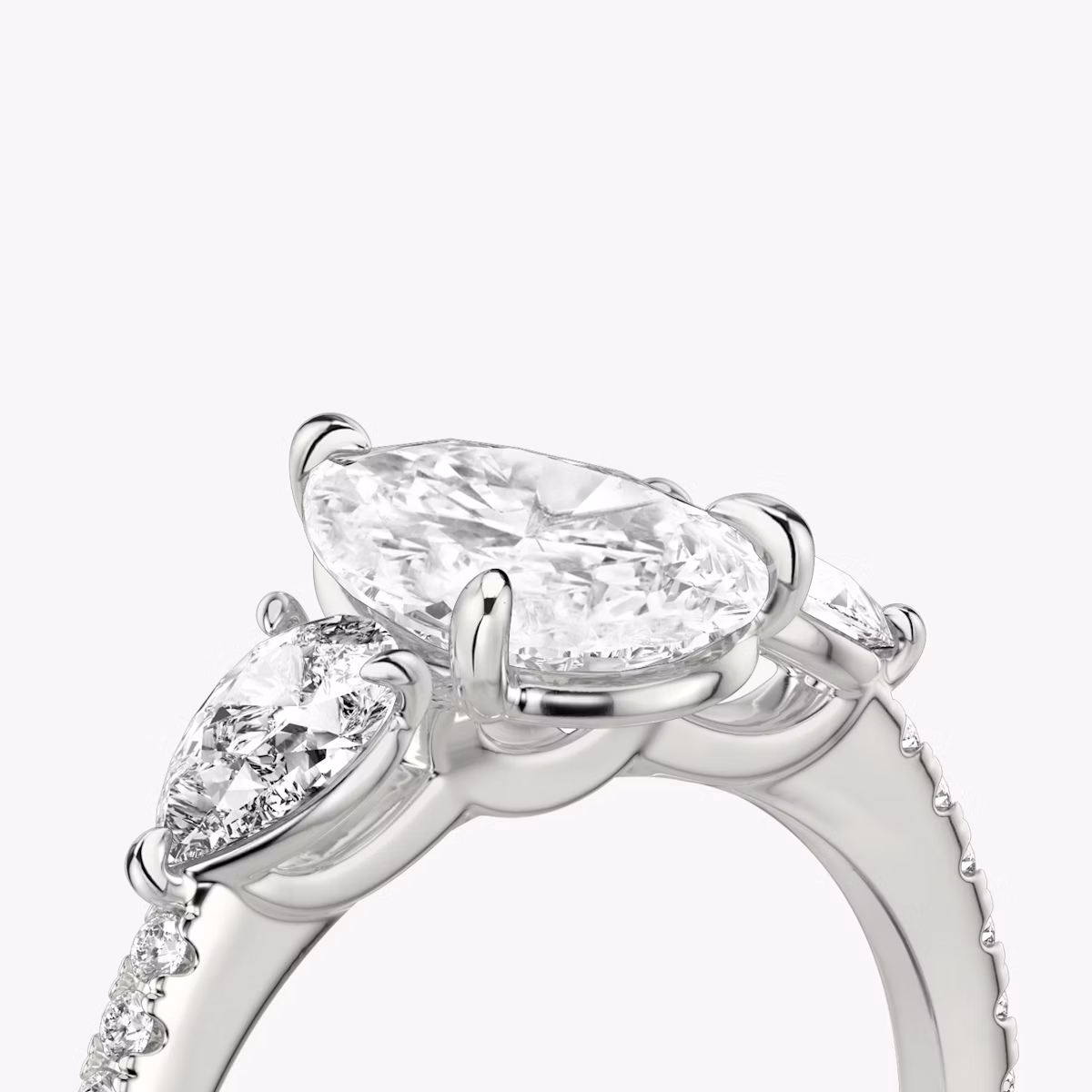 The Three Stone | Pear | 18k | White Gold | bandAccent: Pavé | sideStoneCarat: 0.25ct | sideStoneShape: Pear | diamondOrientation: vertical | caratWeight: other
