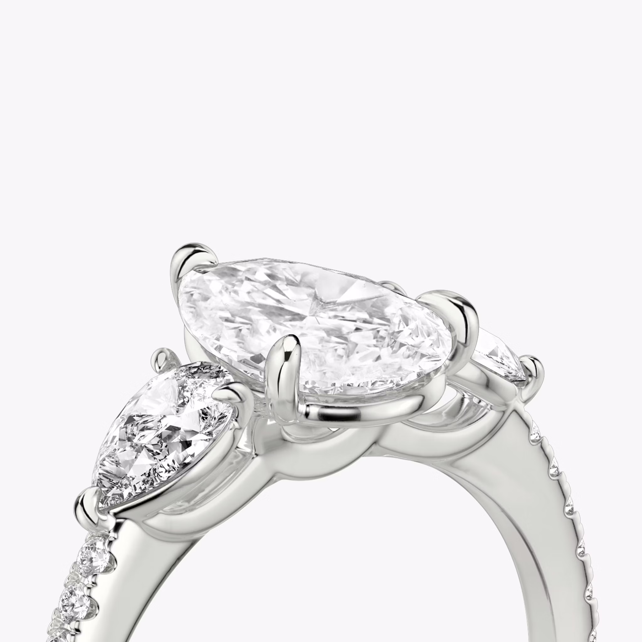 The Three Stone | Pear | Platinum | bandAccent: Pavé | sideStoneCarat: 0.25ct | sideStoneShape: Pear | diamondOrientation: vertical | caratWeight: other