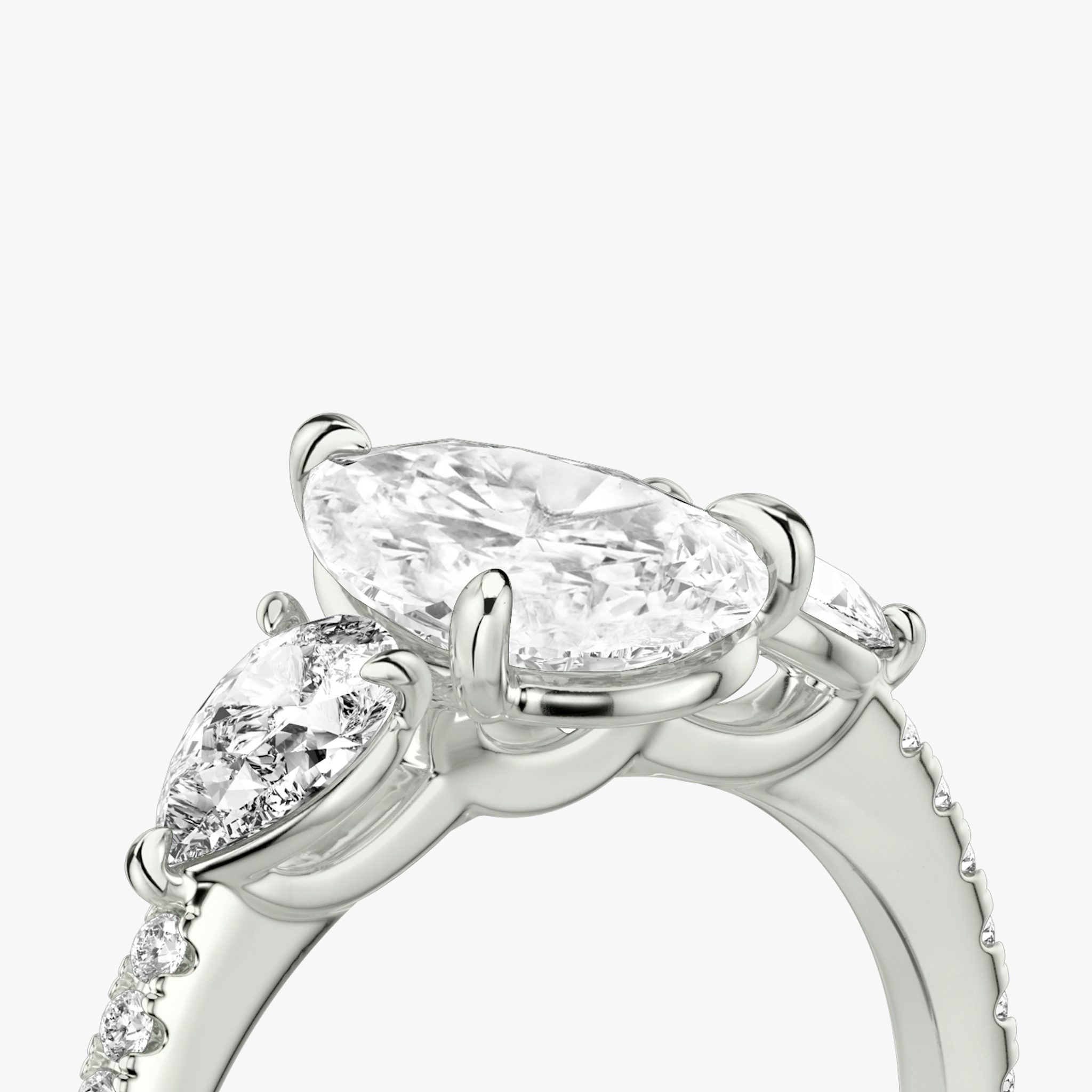 The Three Stone | Pear | Platinum | bandAccent: Pavé | sideStoneCarat: 0.25ct | sideStoneShape: Pear | diamondOrientation: vertical | caratWeight: other