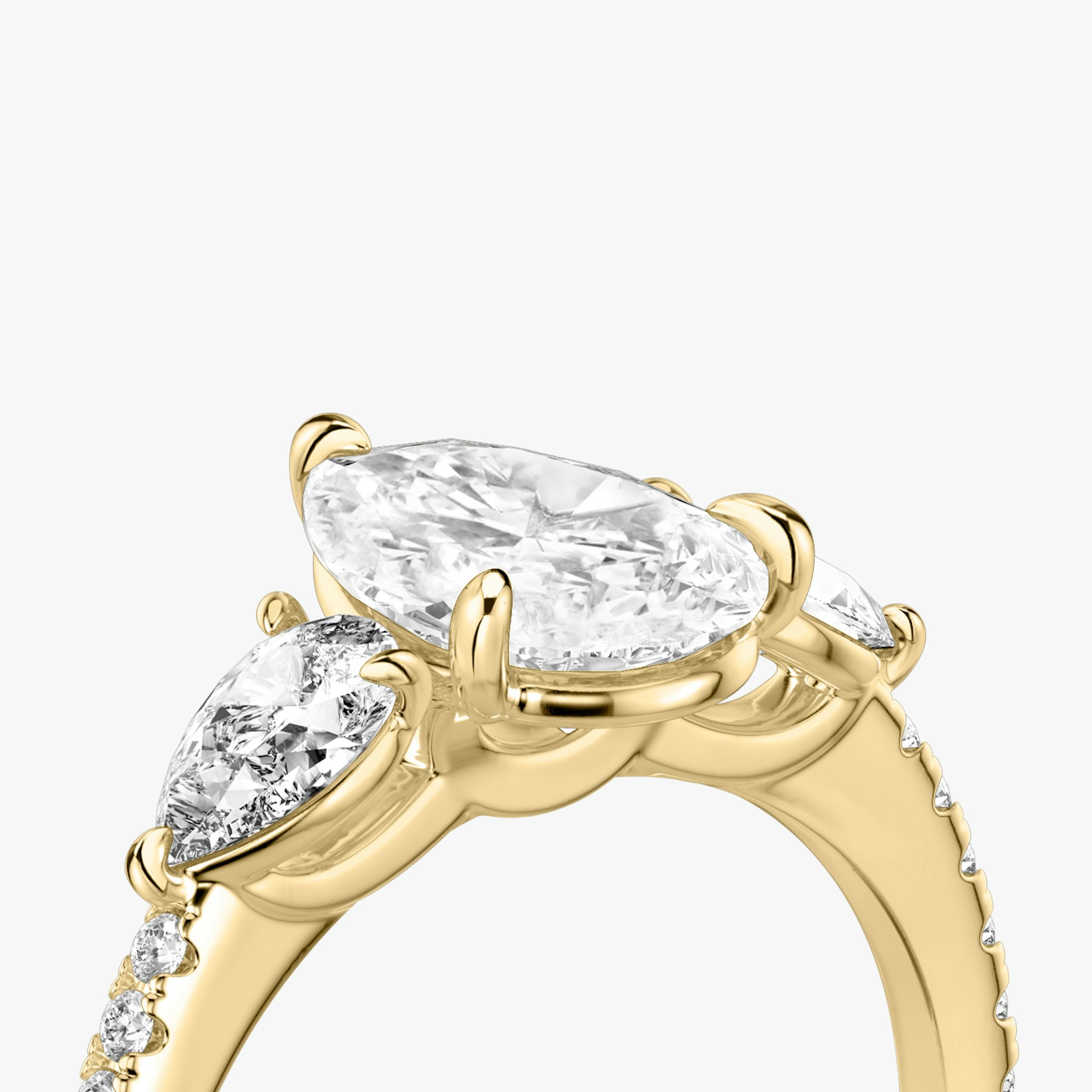 The Three Stone | Pear | 18k | Yellow Gold | bandAccent: Pavé | sideStoneCarat: 0.25ct | sideStoneShape: Pear | diamondOrientation: vertical | caratWeight: other