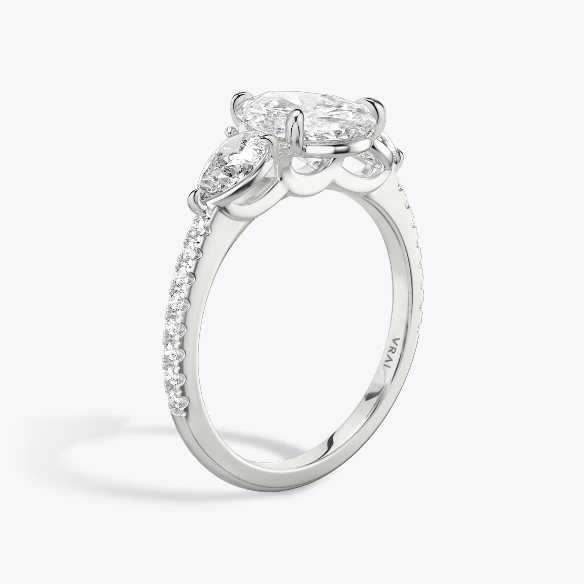 The Three Stone | Pear | Platinum | bandAccent: Pavé | sideStoneCarat: 0.25ct | sideStoneShape: Pear | diamondOrientation: vertical | caratWeight: other