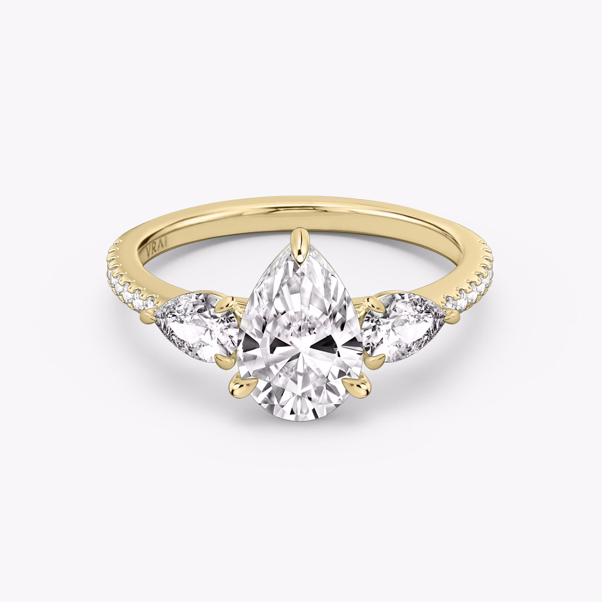 The Three Stone | Pear | 18k | Yellow Gold | bandAccent: Pavé | sideStoneCarat: 0.25ct | sideStoneShape: Pear | diamondOrientation: vertical | caratWeight: other
