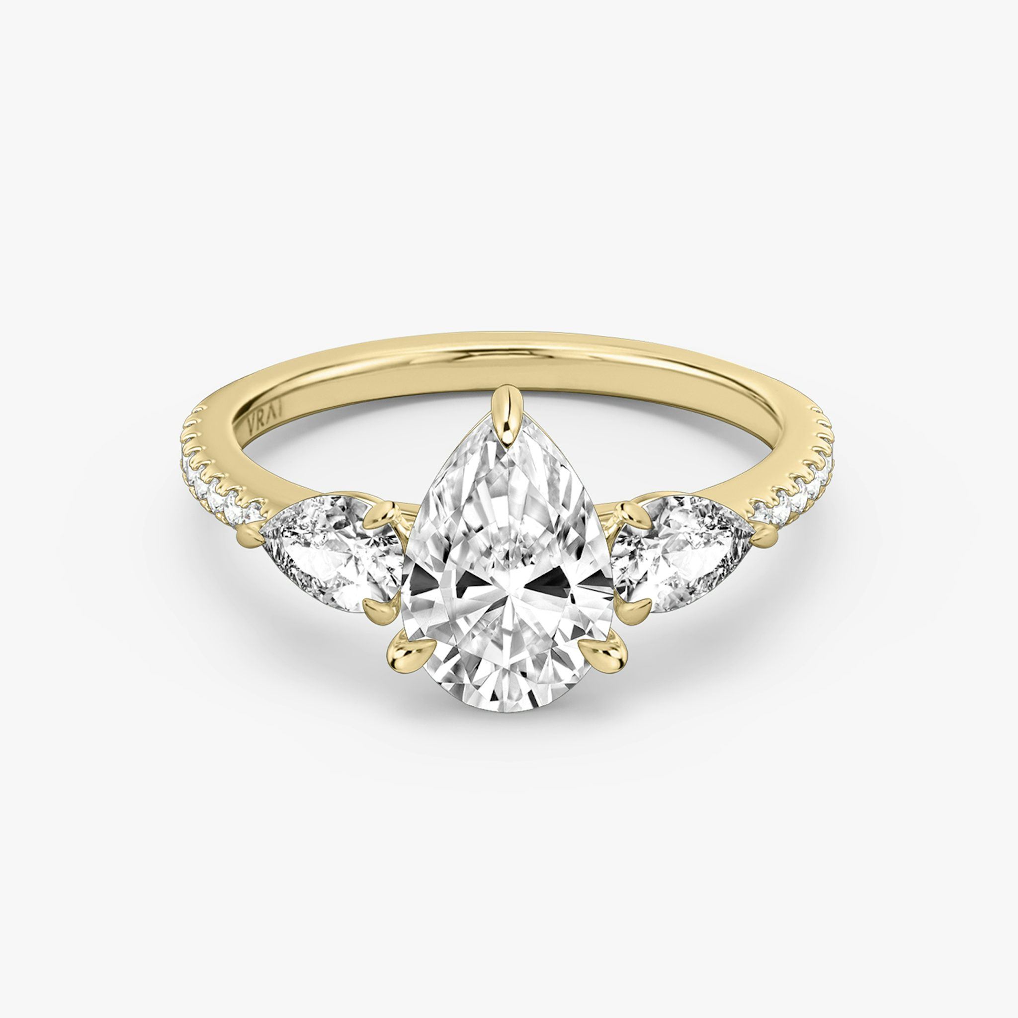 The Three Stone | Pear | 18k | Yellow Gold | bandAccent: Pavé | sideStoneCarat: 0.25ct | sideStoneShape: Pear | diamondOrientation: vertical | caratWeight: other
