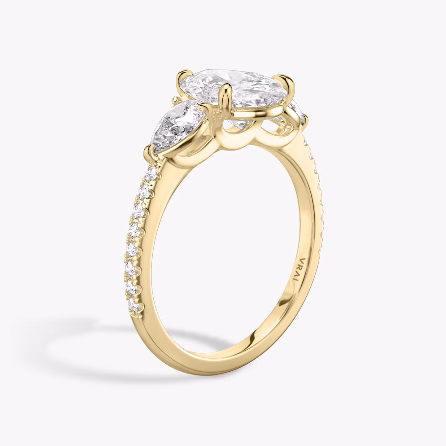 The Three Stone | Pear | 18k | Yellow Gold | bandAccent: Pavé | sideStoneCarat: 0.25ct | sideStoneShape: Pear | diamondOrientation: vertical | caratWeight: other