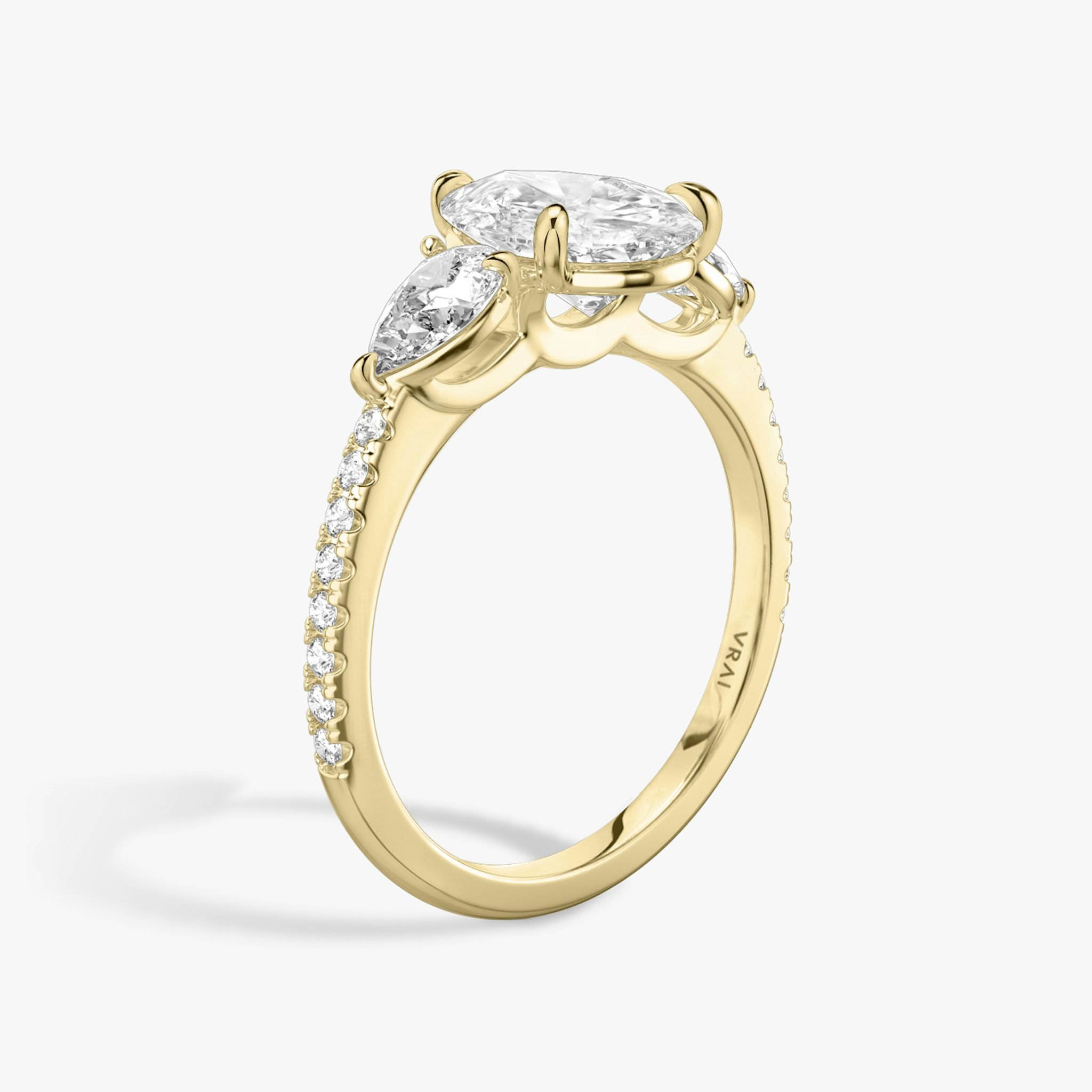 The Three Stone | Pear | 18k | Yellow Gold | bandAccent: Pavé | sideStoneCarat: 0.25ct | sideStoneShape: Pear | diamondOrientation: vertical | caratWeight: other
