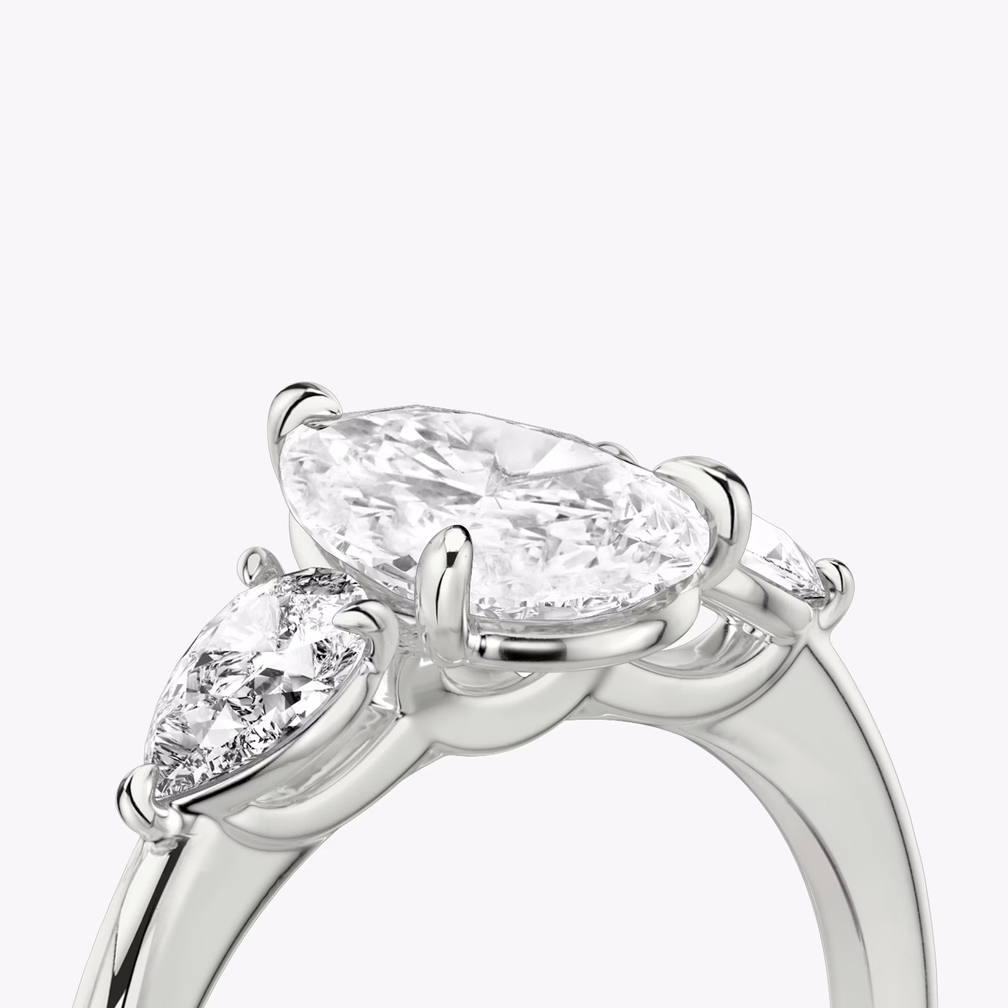 The Three Stone | Pear | Platinum | bandAccent: Plain | sideStoneCarat: 0.25ct | sideStoneShape: Pear | diamondOrientation: vertical | caratWeight: other