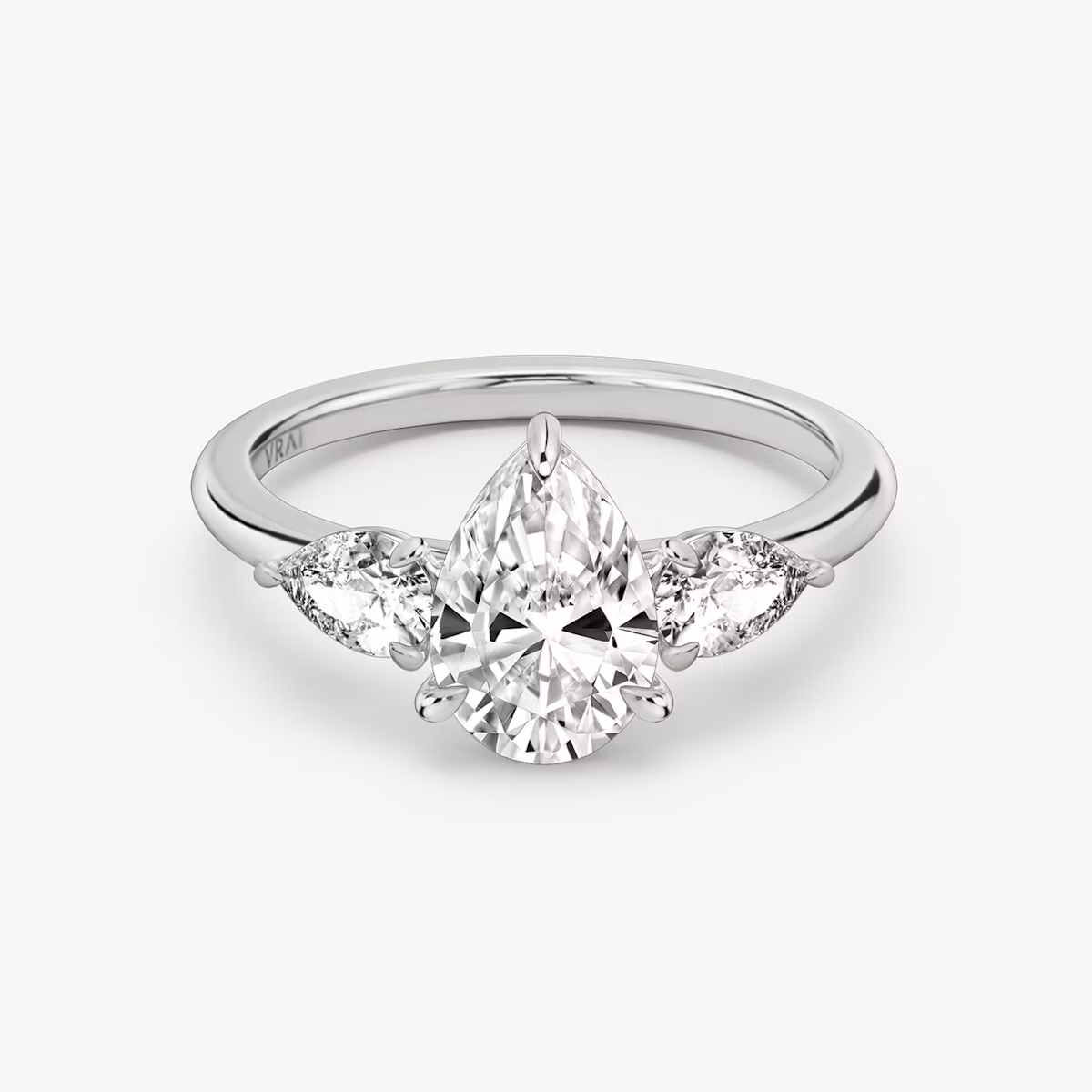 The Three Stone | Pear | Platinum | bandAccent: Plain | sideStoneCarat: 0.25ct | sideStoneShape: Pear | diamondOrientation: vertical | caratWeight: other