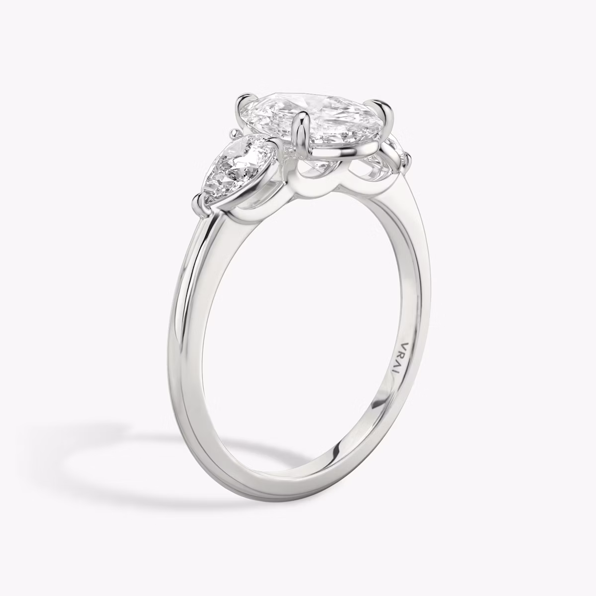 The Three Stone | Pear | Platinum | bandAccent: Plain | sideStoneCarat: 0.25ct | sideStoneShape: Pear | diamondOrientation: vertical | caratWeight: other
