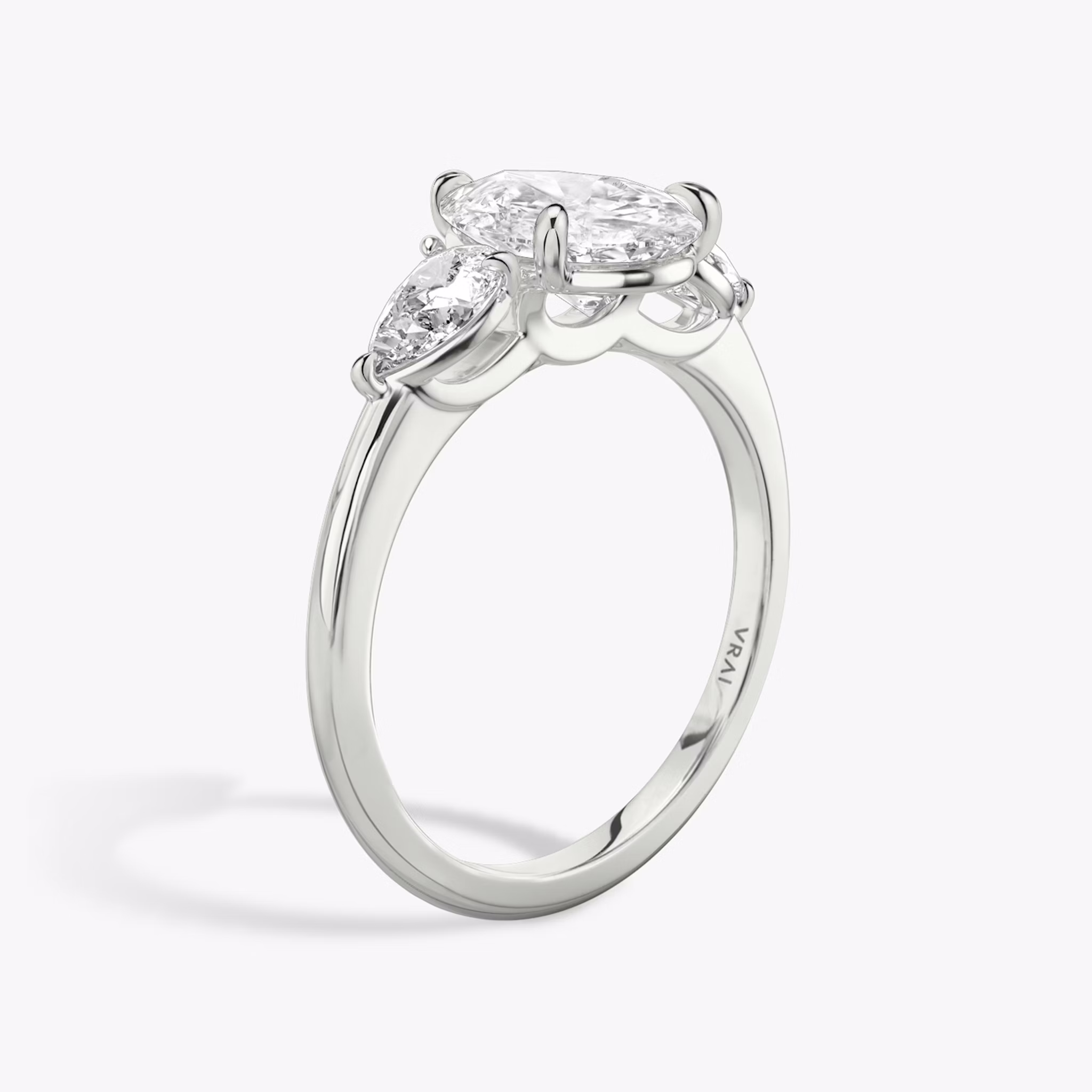The Three Stone | Pear | Platinum | bandAccent: Plain | sideStoneCarat: 0.25ct | sideStoneShape: Pear | diamondOrientation: vertical | caratWeight: other