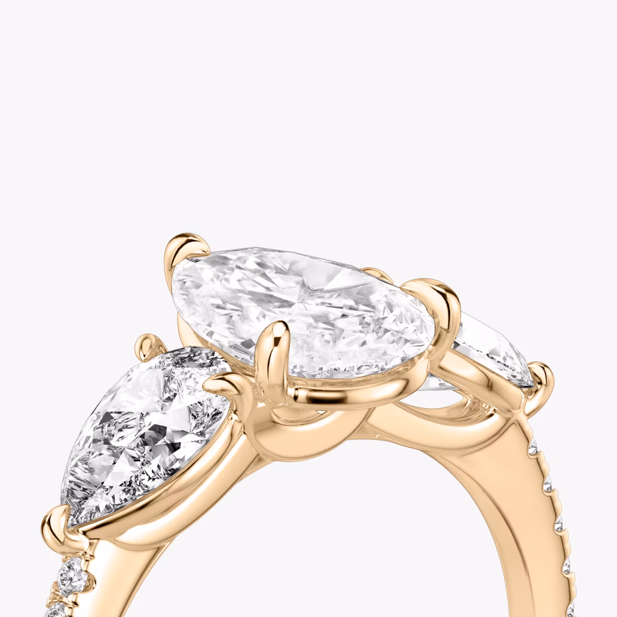 The Three Stone | Pear | 14k | Rose Gold | bandAccent: Pavé | sideStoneCarat: 0.50ct | sideStoneShape: Pear | diamondOrientation: vertical | caratWeight: other