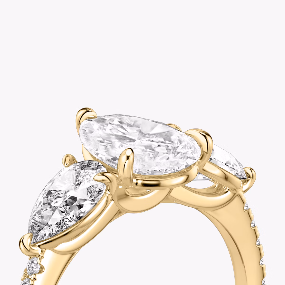 The Three Stone | Pear | 18k | Yellow Gold | bandAccent: Pavé | sideStoneCarat: 0.50ct | sideStoneShape: Pear | diamondOrientation: vertical | caratWeight: other