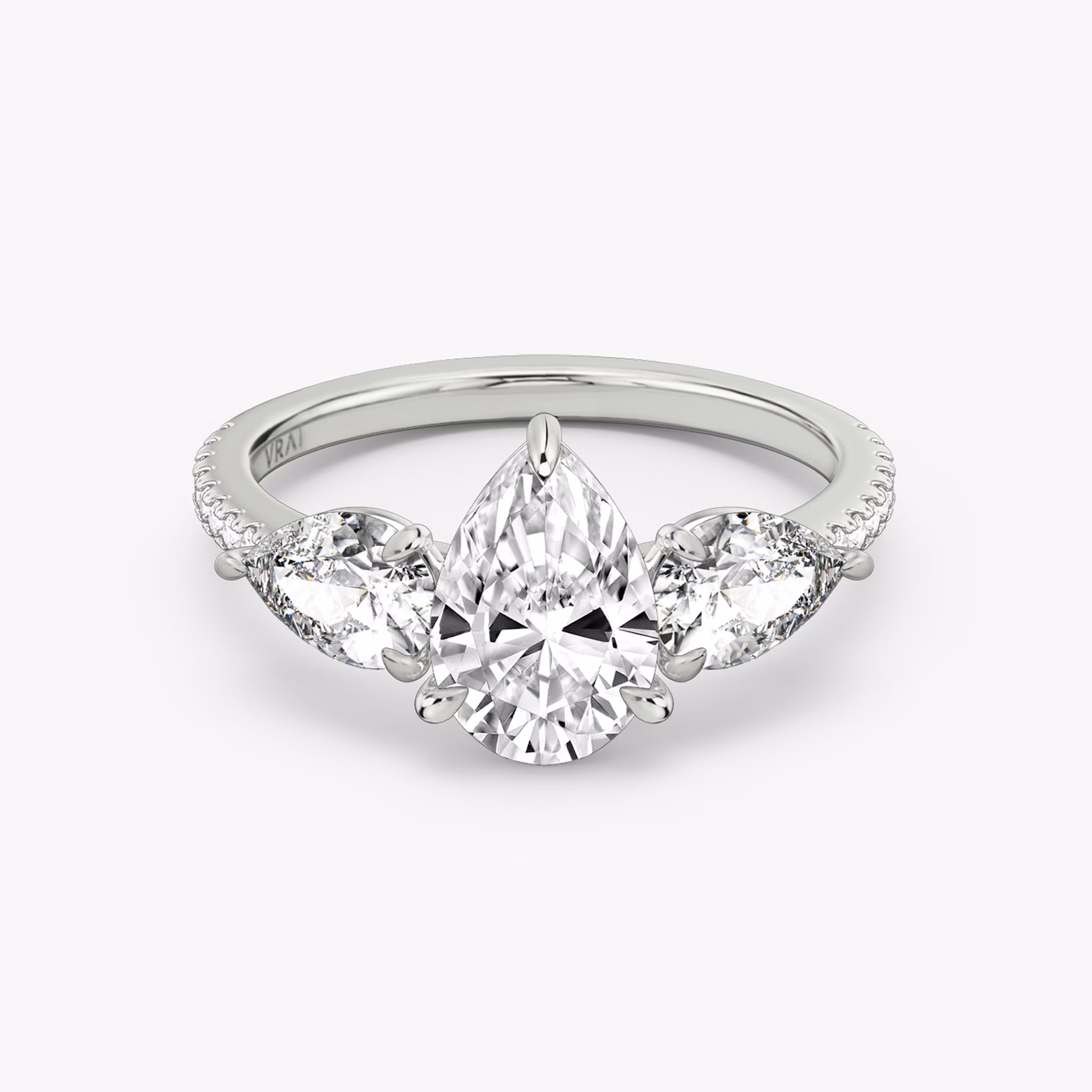 The Three Stone | Pear | 18k | White Gold | bandAccent: Pavé | sideStoneCarat: 0.50ct | sideStoneShape: Pear | diamondOrientation: vertical | caratWeight: other
