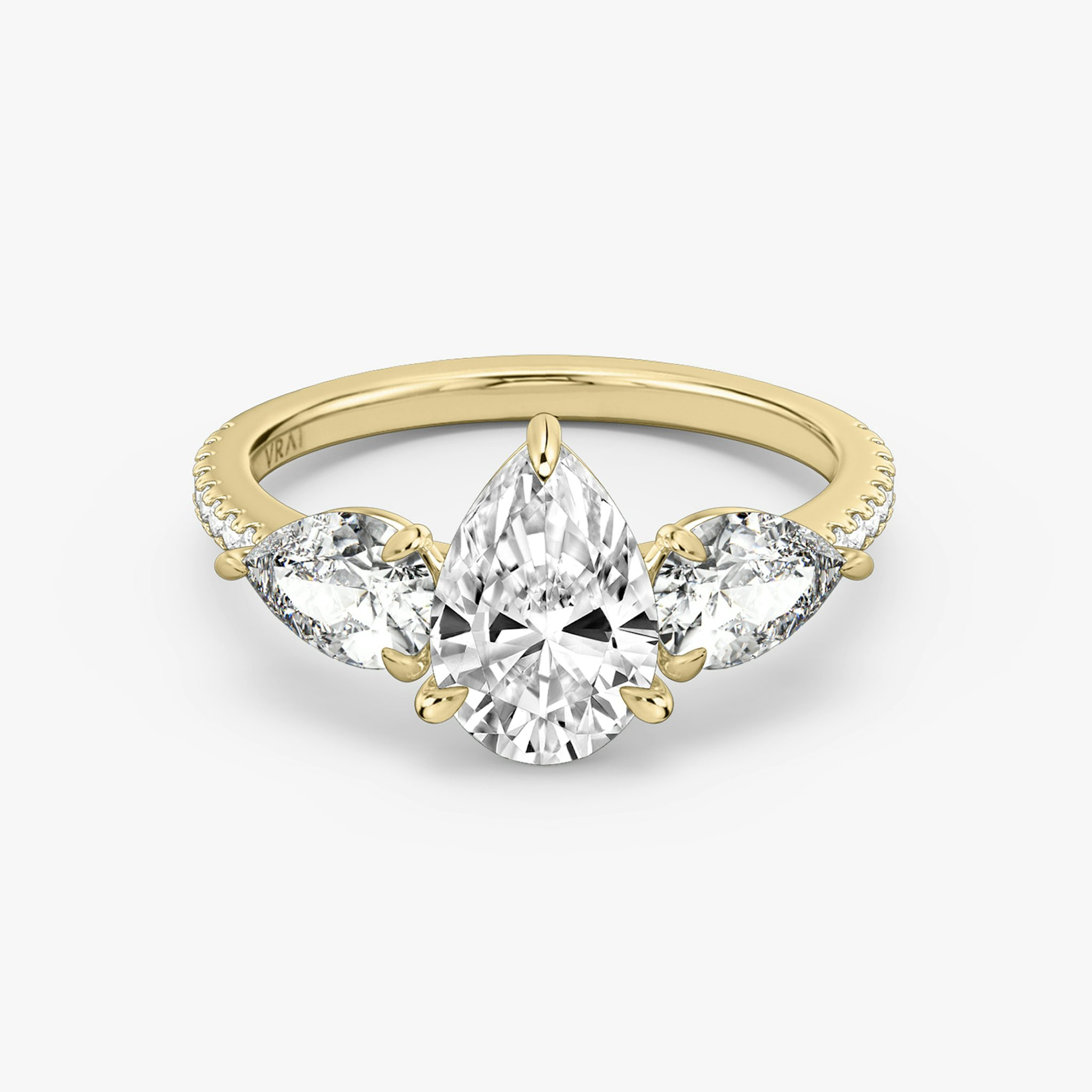 The Three Stone | Pear | 18k | Yellow Gold | bandAccent: Pavé | sideStoneCarat: 0.50ct | sideStoneShape: Pear | diamondOrientation: vertical | caratWeight: other