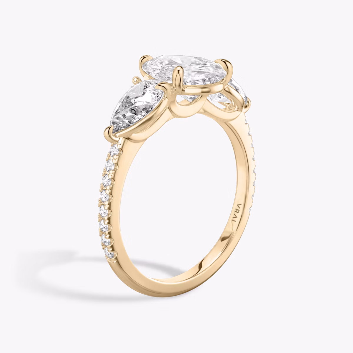 The Three Stone | Pear | 14k | Rose Gold | bandAccent: Pavé | sideStoneCarat: 0.50ct | sideStoneShape: Pear | diamondOrientation: vertical | caratWeight: other