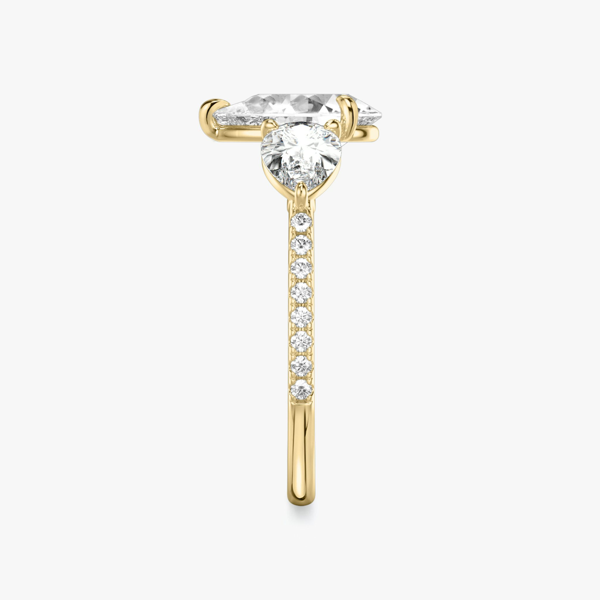 The Three Stone | Pear | 18k | Yellow Gold | bandAccent: Pavé | sideStoneCarat: 0.50ct | sideStoneShape: Pear | diamondOrientation: vertical | caratWeight: other
