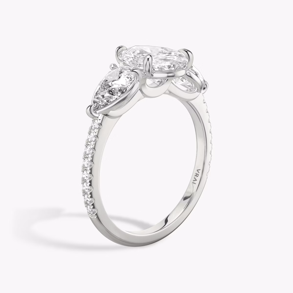 The Three Stone | Pear | Platinum | bandAccent: Pavé | sideStoneCarat: 0.50ct | sideStoneShape: Pear | diamondOrientation: vertical | caratWeight: other