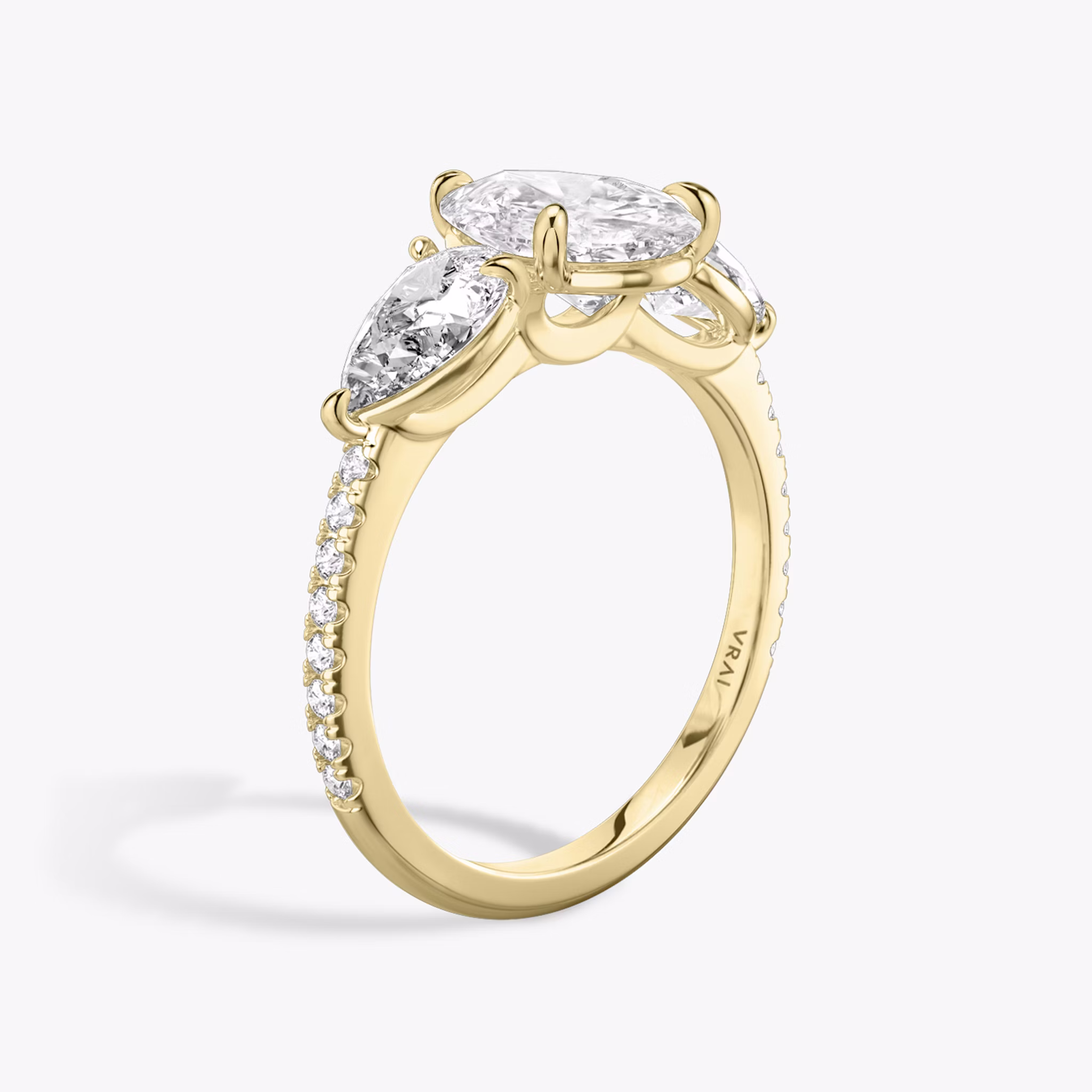 The Three Stone | Pear | 18k | Yellow Gold | bandAccent: Pavé | sideStoneCarat: 0.50ct | sideStoneShape: Pear | diamondOrientation: vertical | caratWeight: other
