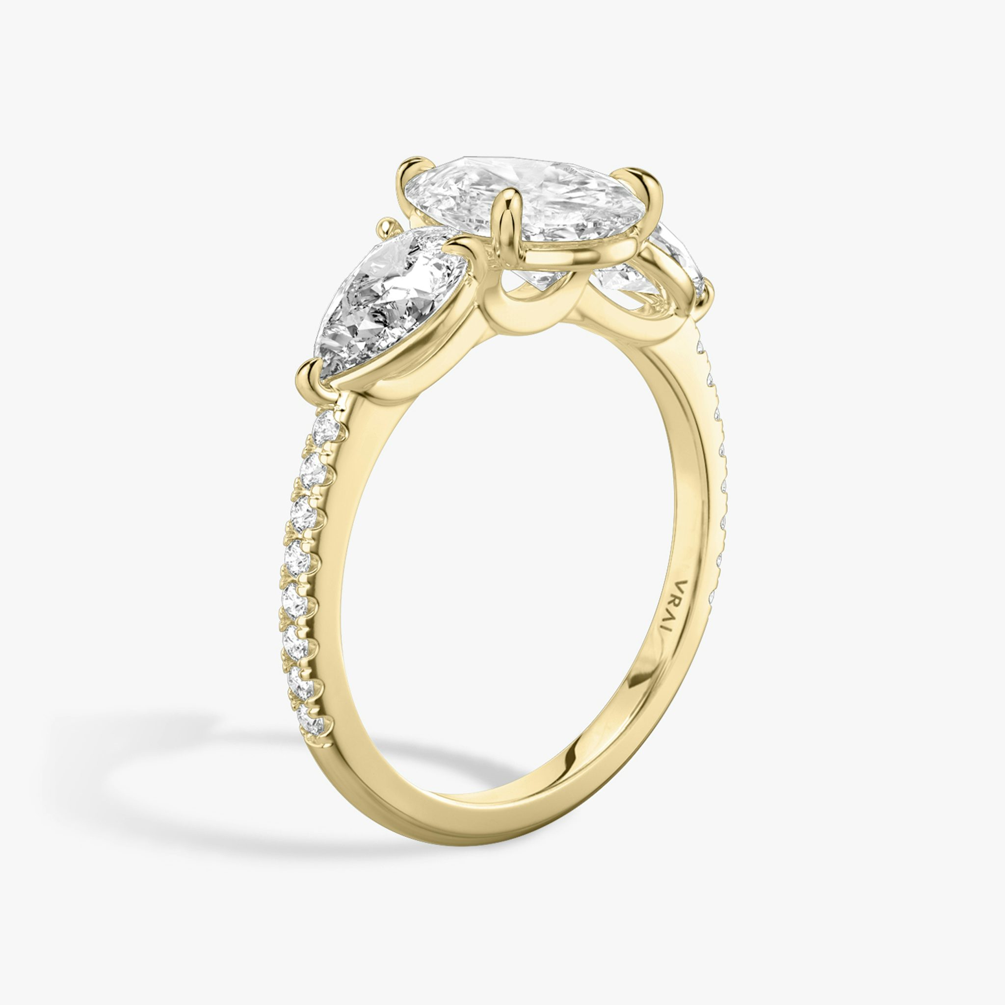 The Three Stone | Pear | 18k | Yellow Gold | bandAccent: Pavé | sideStoneCarat: 0.50ct | sideStoneShape: Pear | diamondOrientation: vertical | caratWeight: other