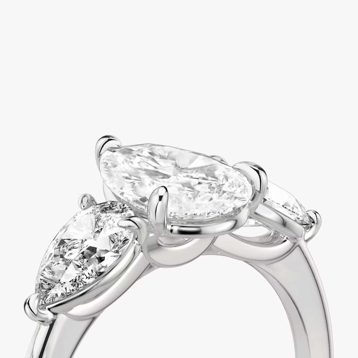 The Three Stone | Pear | Platinum | bandAccent: Plain | sideStoneCarat: 0.50ct | sideStoneShape: Pear | diamondOrientation: vertical | caratWeight: other