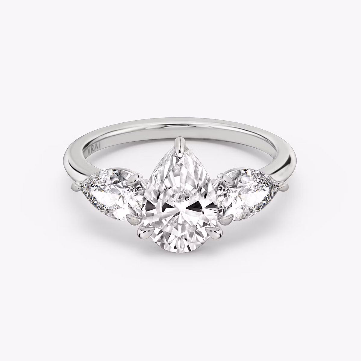 The Three Stone | Pear | Platinum | bandAccent: Plain | sideStoneCarat: 0.50ct | sideStoneShape: Pear | diamondOrientation: vertical | caratWeight: other