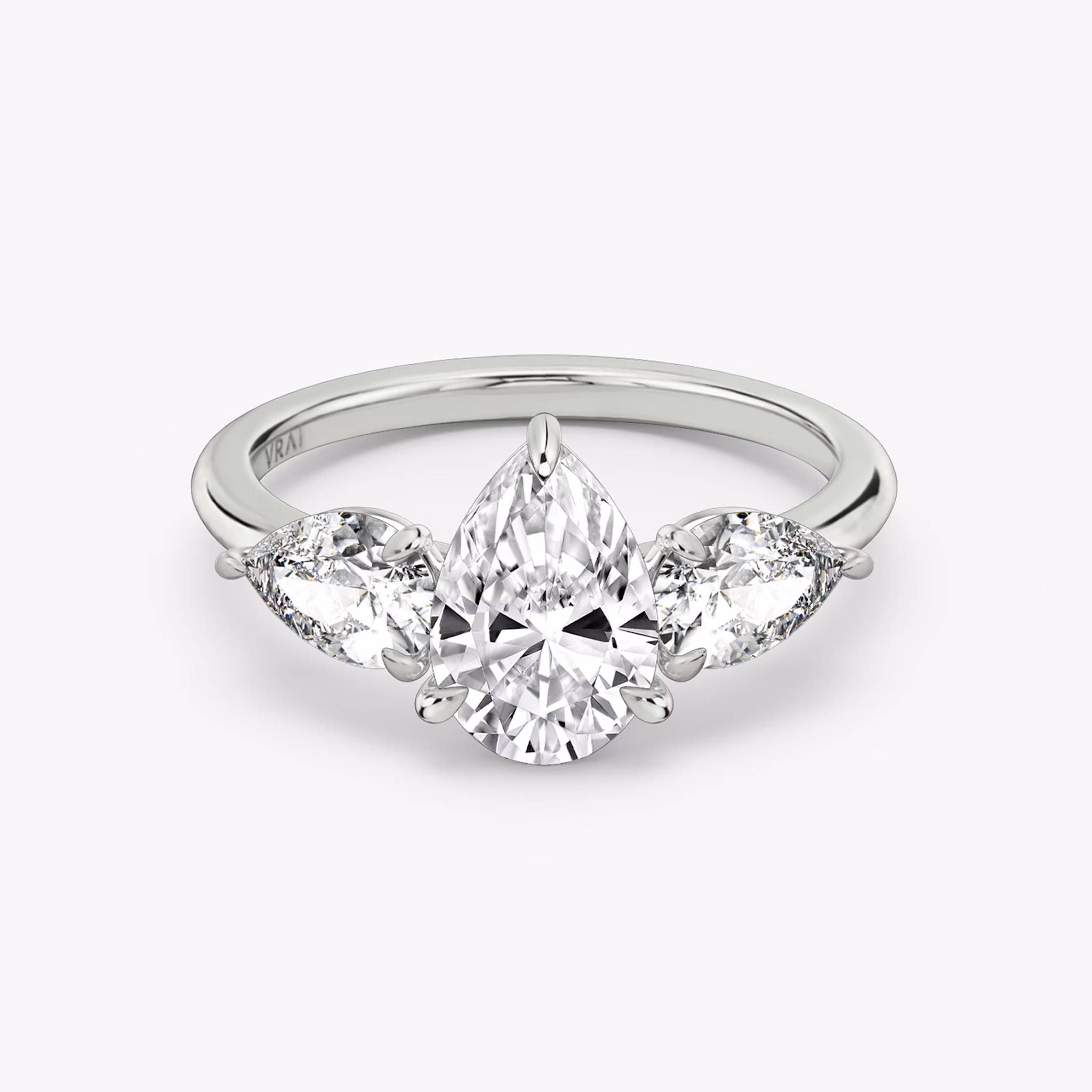 The Three Stone | Pear | Platinum | bandAccent: Plain | sideStoneCarat: 0.50ct | sideStoneShape: Pear | diamondOrientation: vertical | caratWeight: other