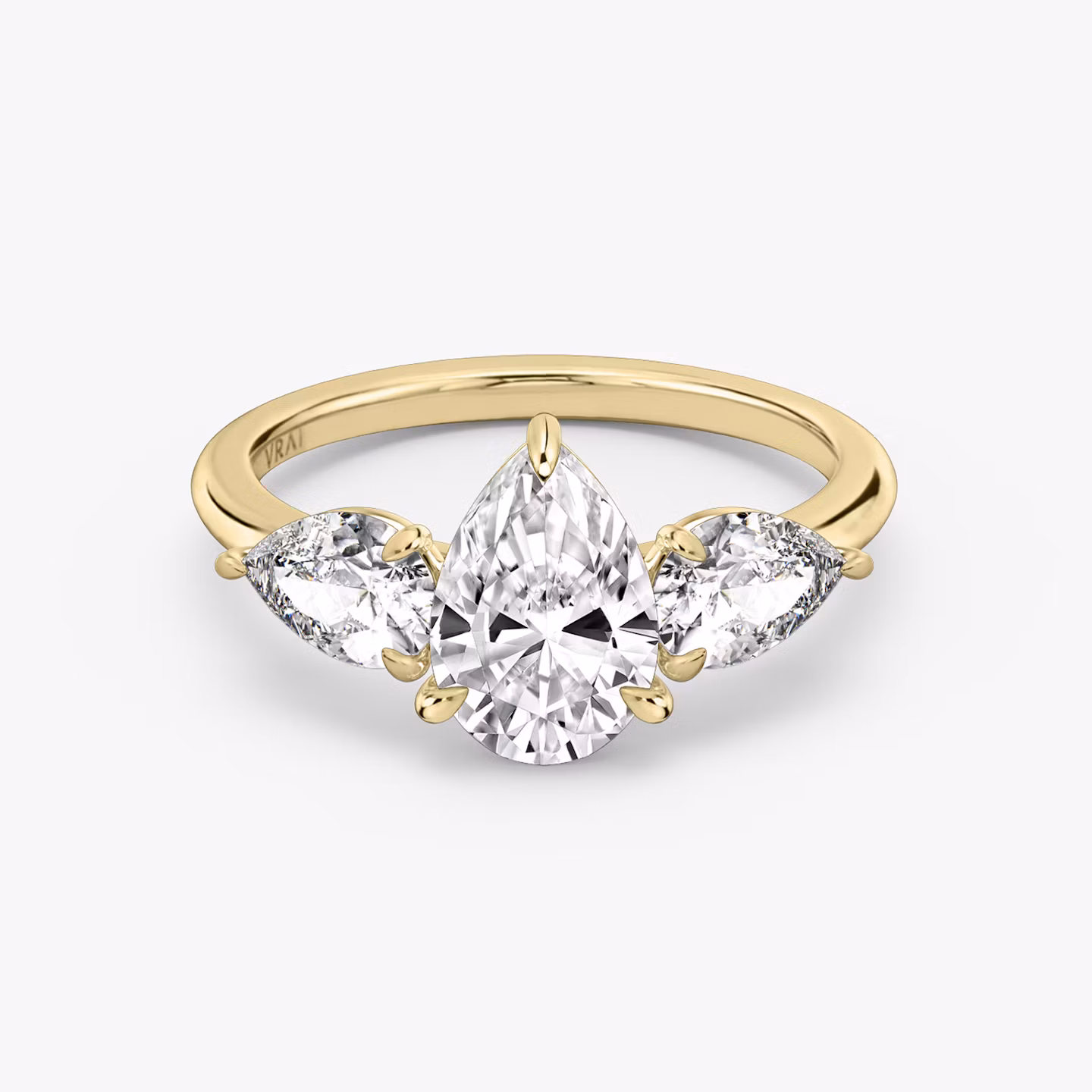 The Three Stone | Pear | 18k | Yellow Gold | bandAccent: Plain | sideStoneCarat: 0.50ct | sideStoneShape: Pear | diamondOrientation: vertical | caratWeight: other