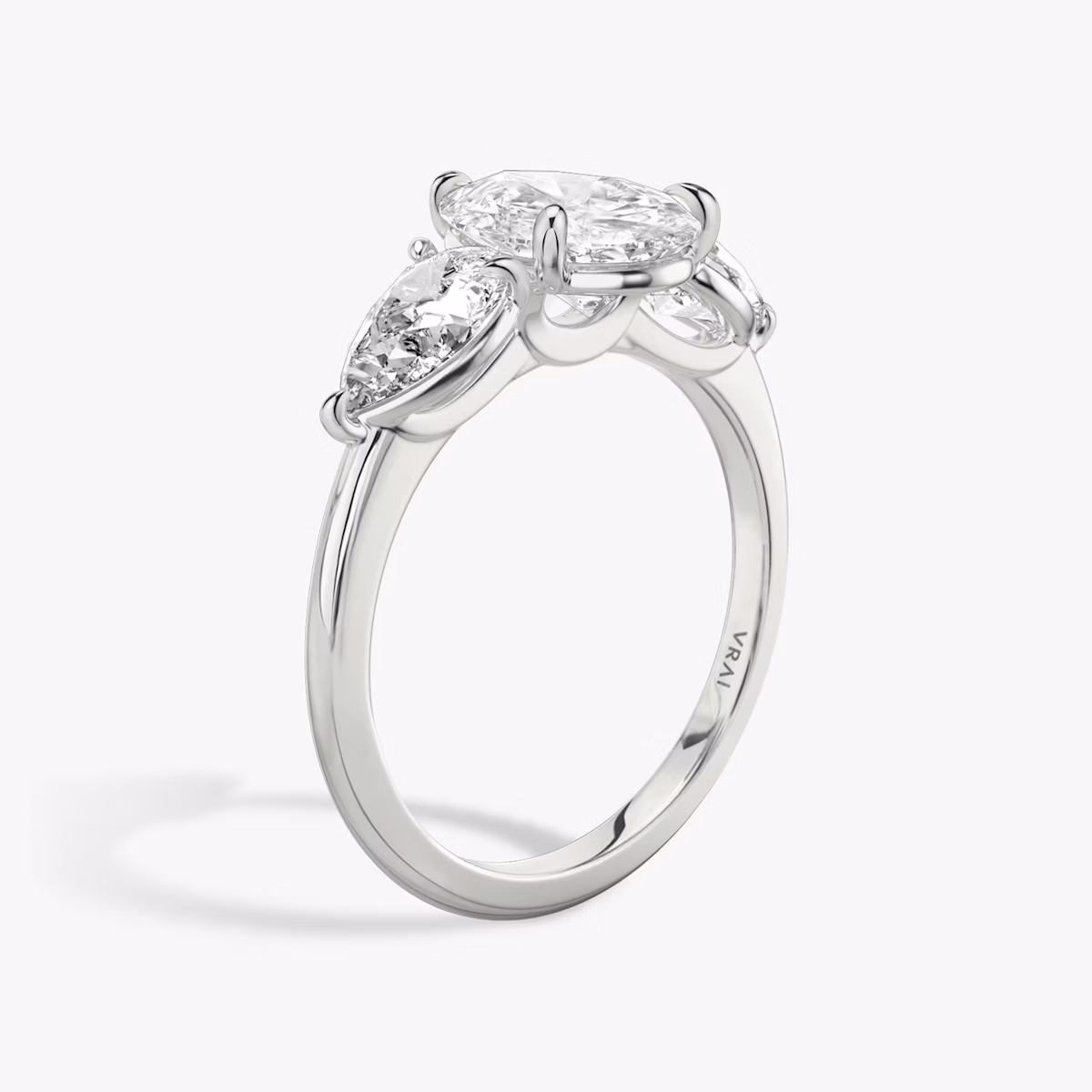 The Three Stone | Pear | Platinum | bandAccent: Plain | sideStoneCarat: 0.50ct | sideStoneShape: Pear | diamondOrientation: vertical | caratWeight: other