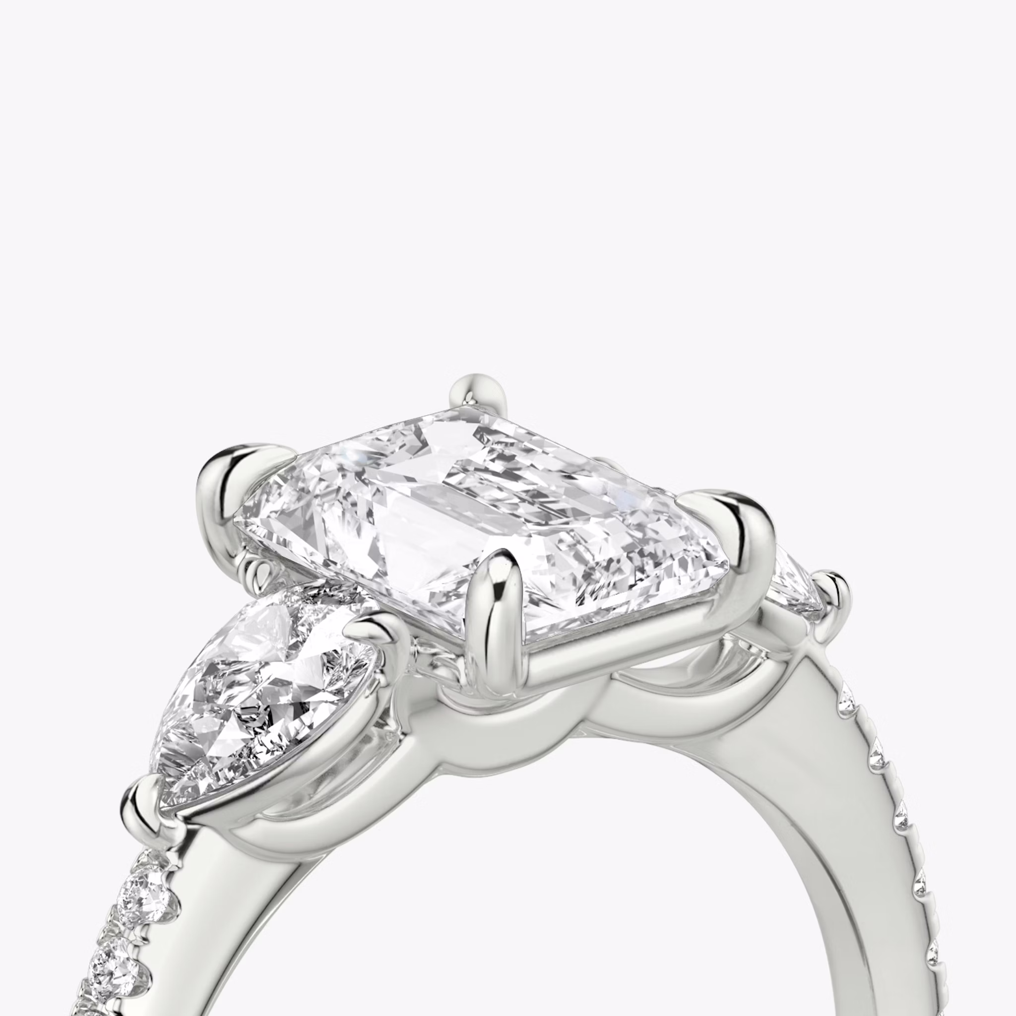 The Three Stone | Radiant | Platinum | bandAccent: Pavé | sideStoneCarat: 0.25ct | sideStoneShape: Pear | diamondOrientation: vertical | caratWeight: other