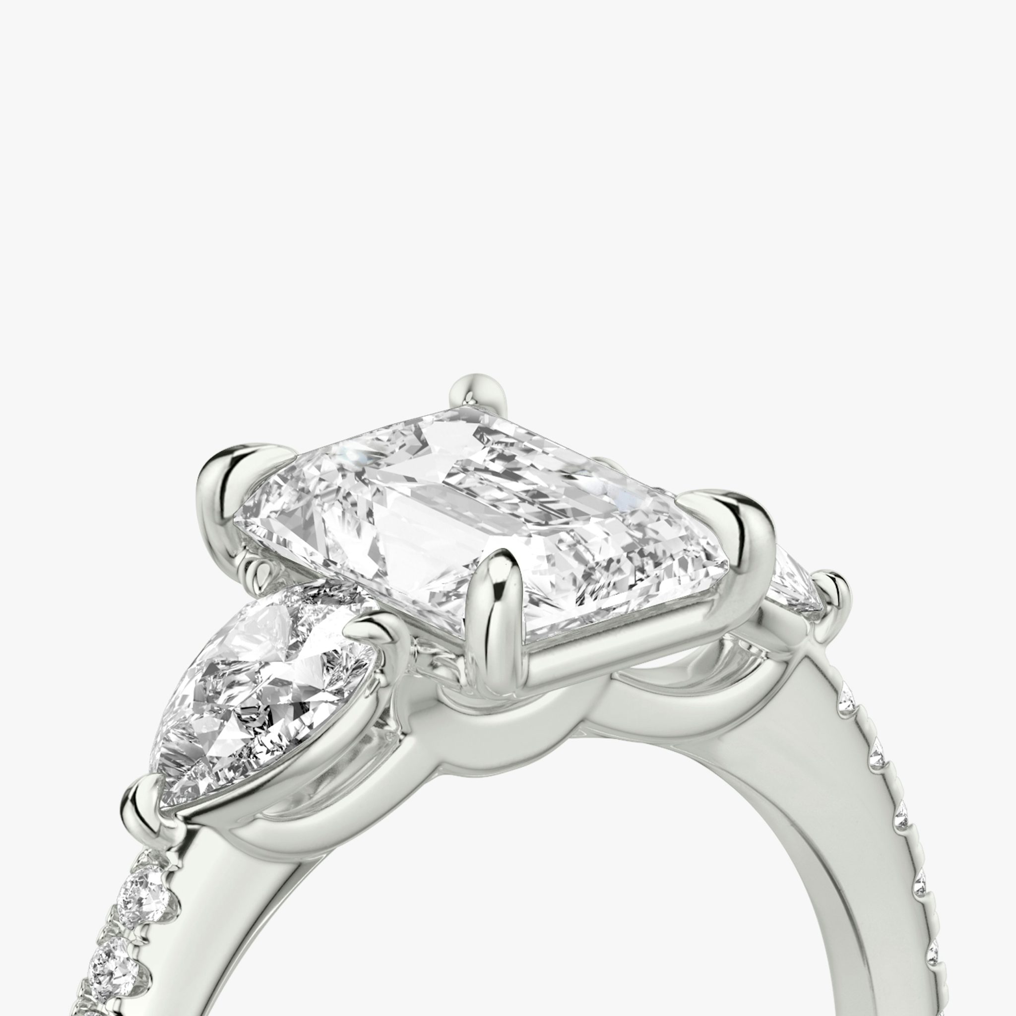 The Three Stone | Radiant | Platinum | bandAccent: Pavé | sideStoneCarat: 0.25ct | sideStoneShape: Pear | diamondOrientation: vertical | caratWeight: other