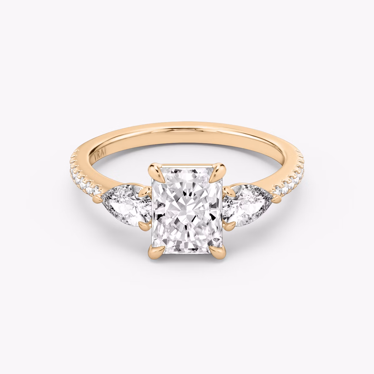 The Three Stone | Radiant | 14k | Rose Gold | bandAccent: Pavé | sideStoneCarat: 0.25ct | sideStoneShape: Pear | diamondOrientation: vertical | caratWeight: other