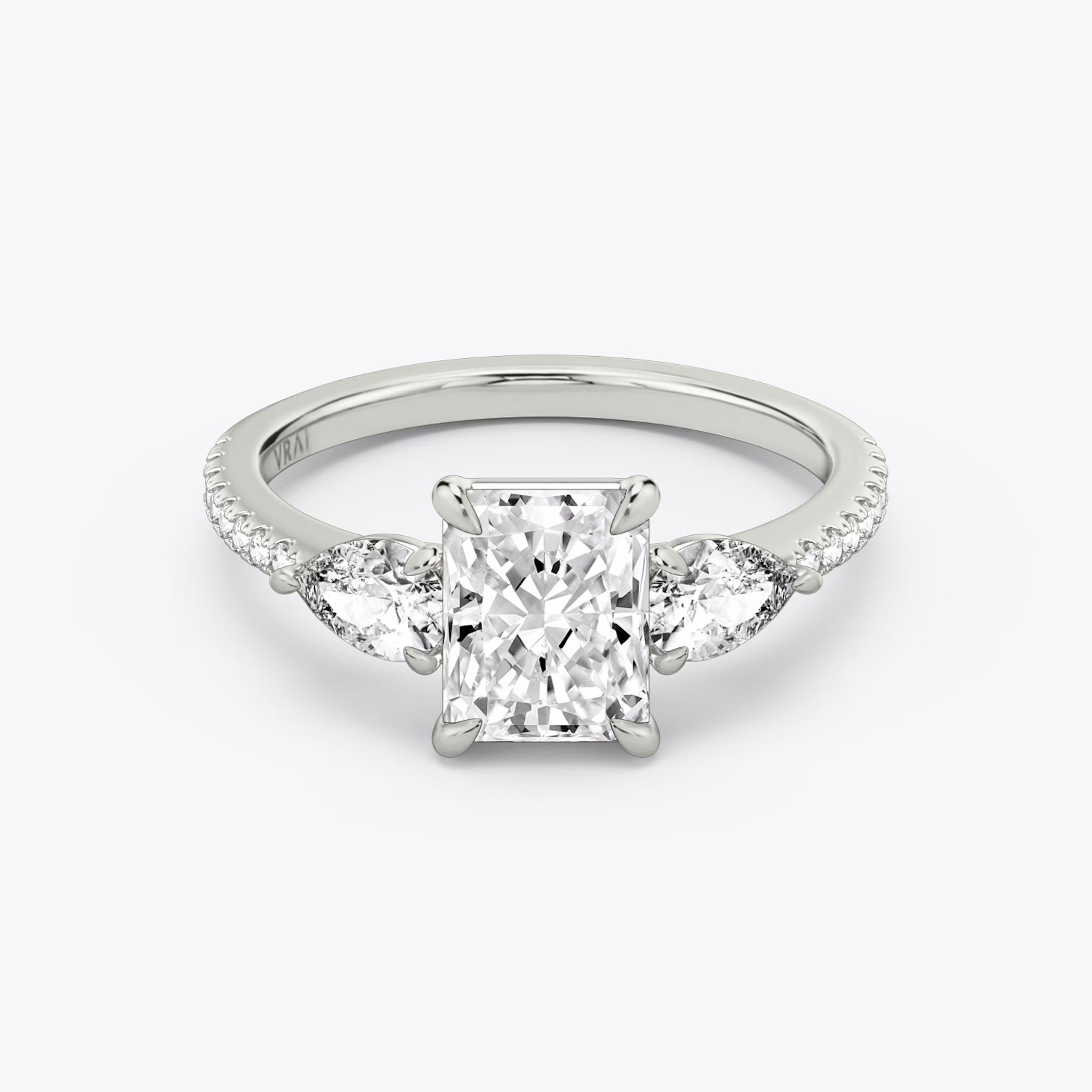The Three Stone | Radiant | Platinum | bandAccent: Pavé | sideStoneCarat: 0.25ct | sideStoneShape: Pear | diamondOrientation: vertical | caratWeight: other
