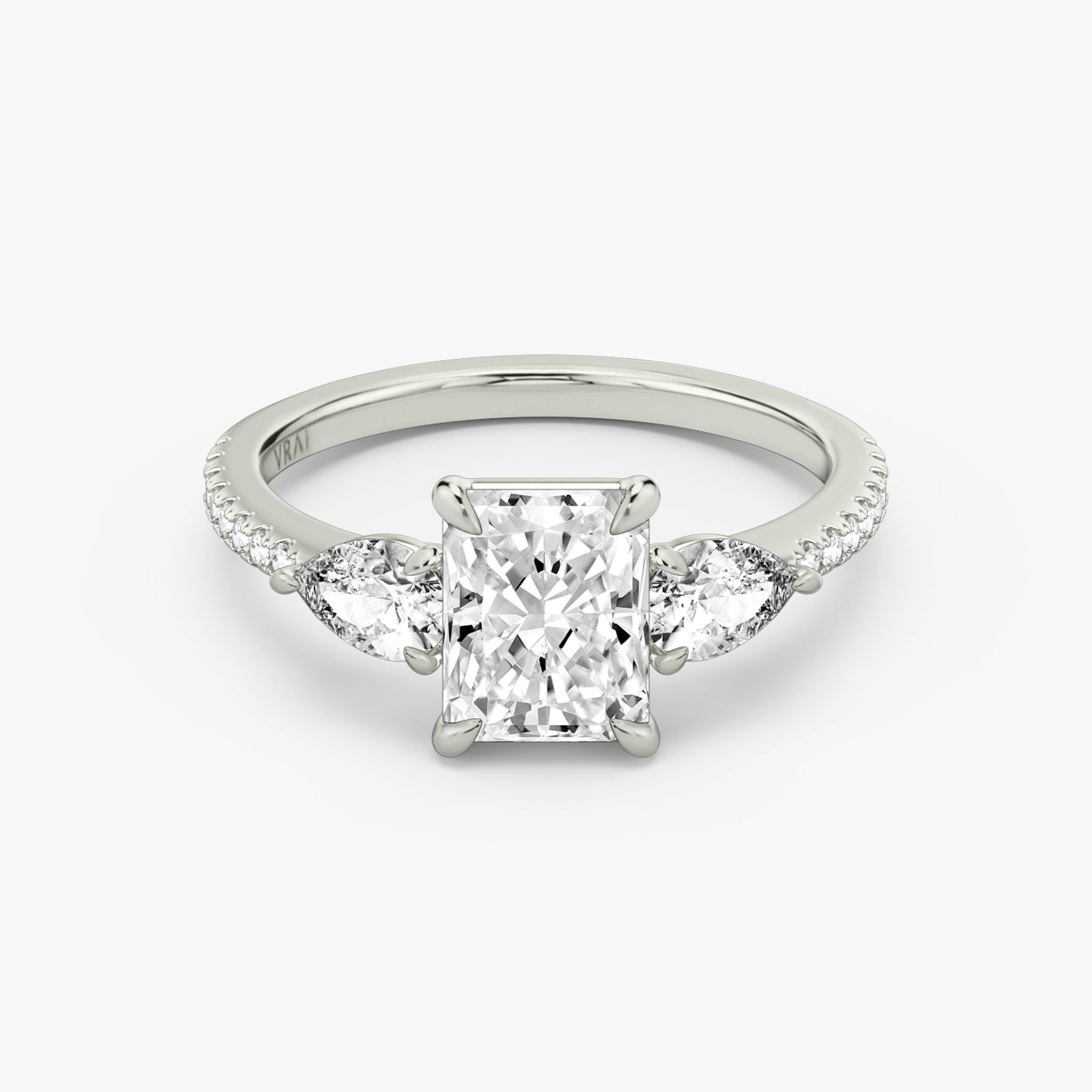 The Three Stone | Radiant | Platinum | bandAccent: Pavé | sideStoneCarat: 0.25ct | sideStoneShape: Pear | diamondOrientation: vertical | caratWeight: other